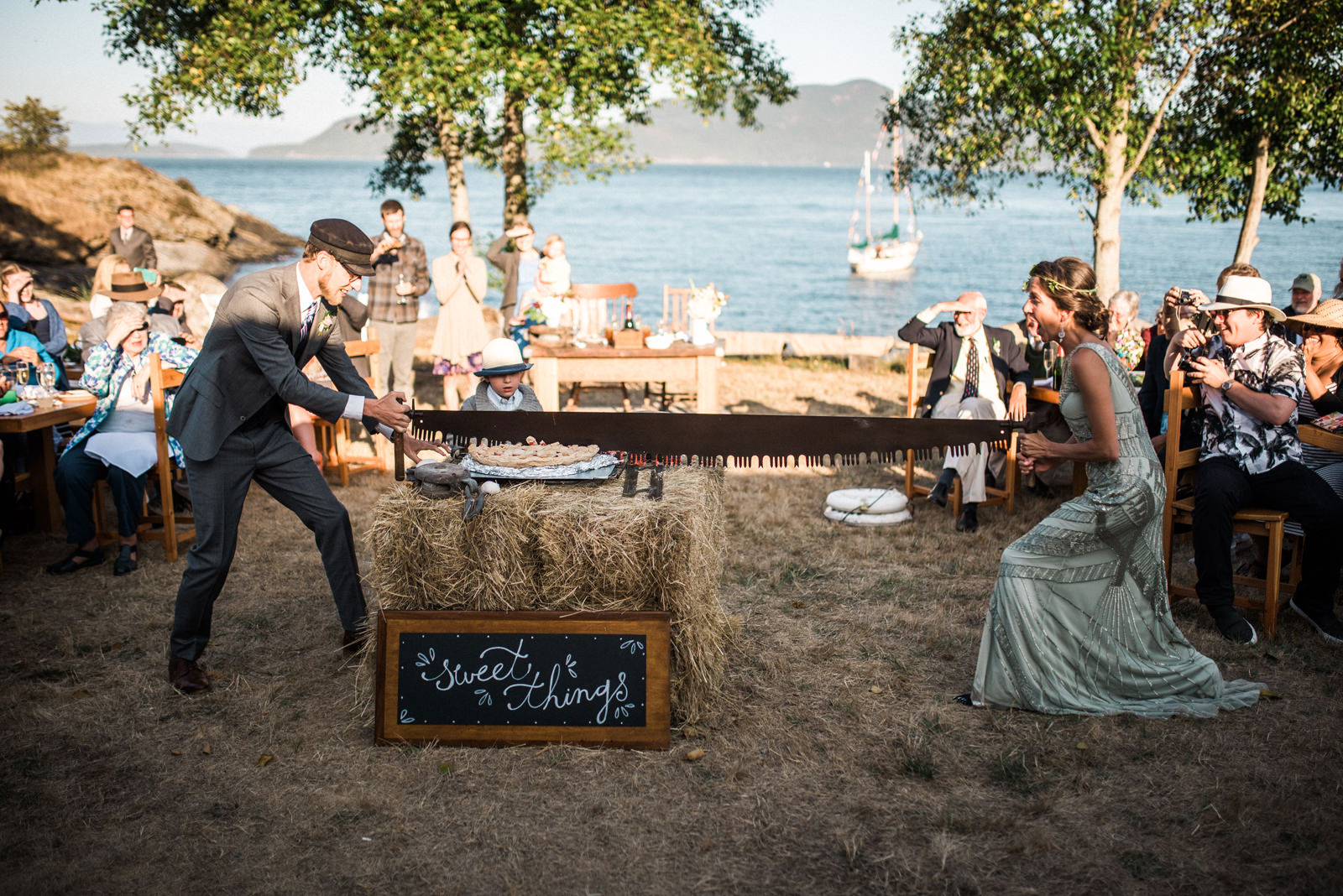 075-bride-and-groom-using-band-saw-to-cut-wedding-pie-by-orcas-island-wedding-photographer.jpg