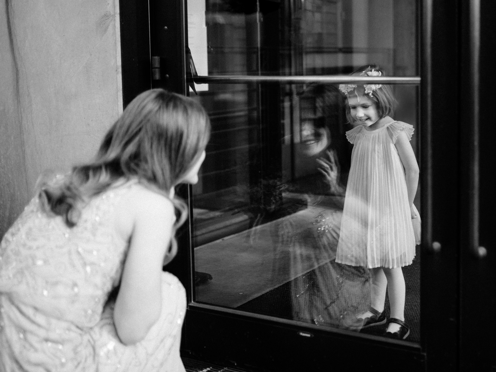 213-documentary-wedding-photo-in-seattle-with-bride-seeing-flower-girl-through-window.jpg