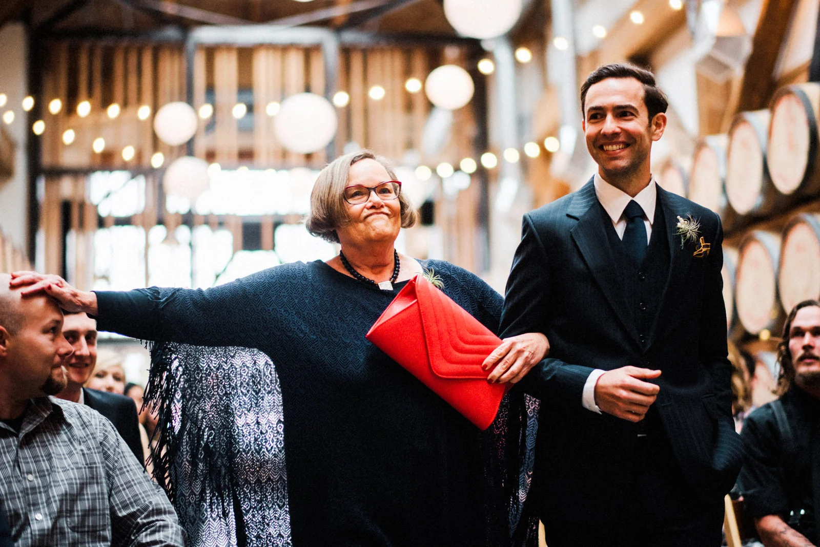 214-westland-distillery-wedding-moment-with-groom-and-mother-walking-down-aisle.jpg