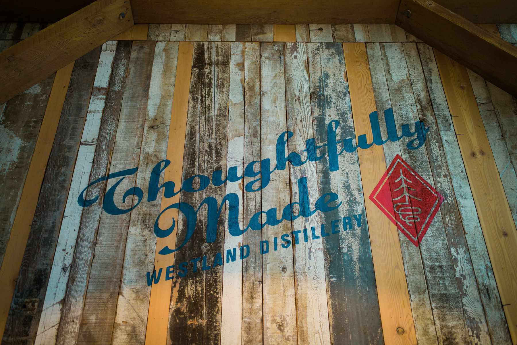 046-hand-painted-sign-on-weathered-reclaimed-wood-at-westland-distillery.jpg