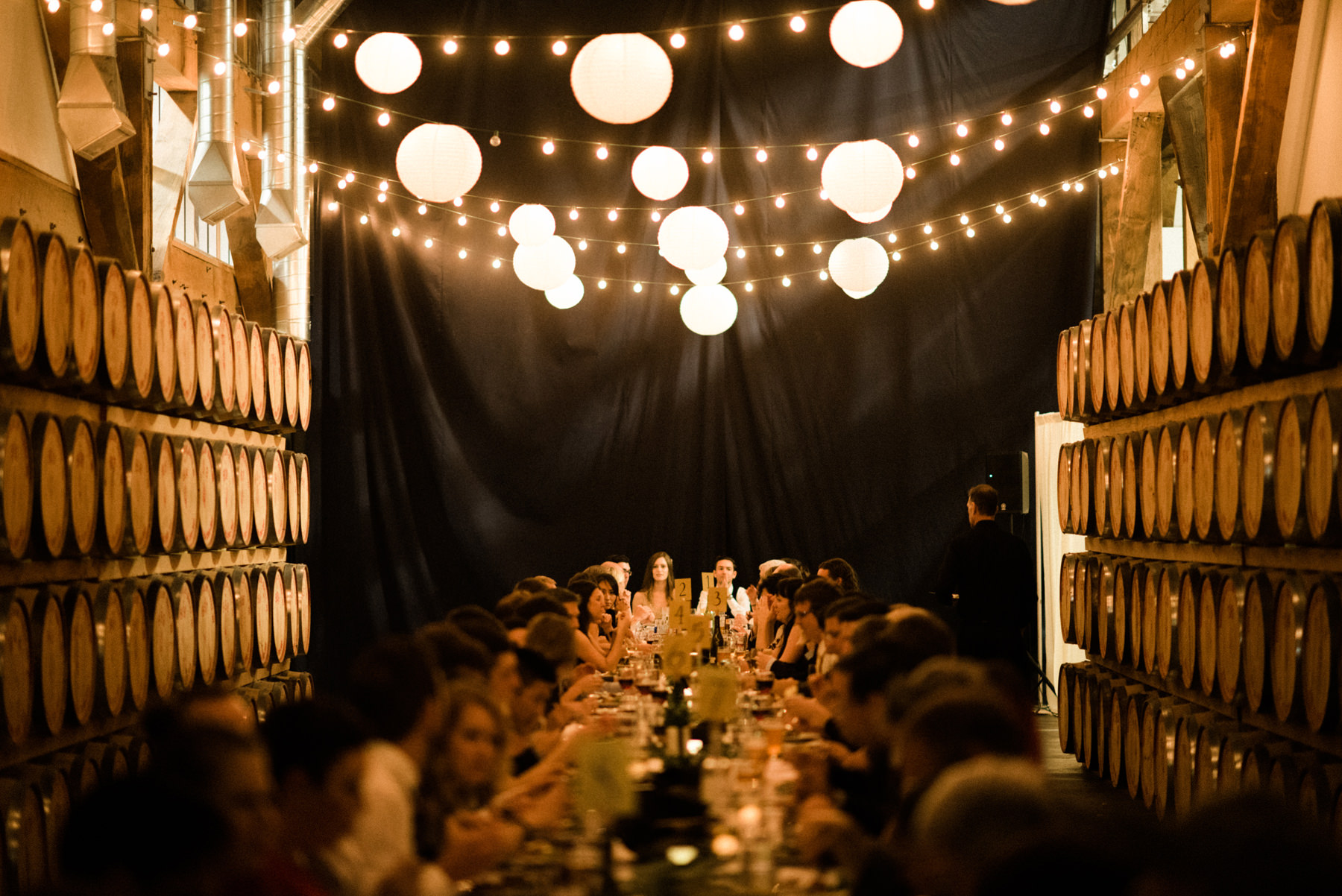 067-long-table-wedding-dinner-under-string-lights-at-westland-distillery.jpg