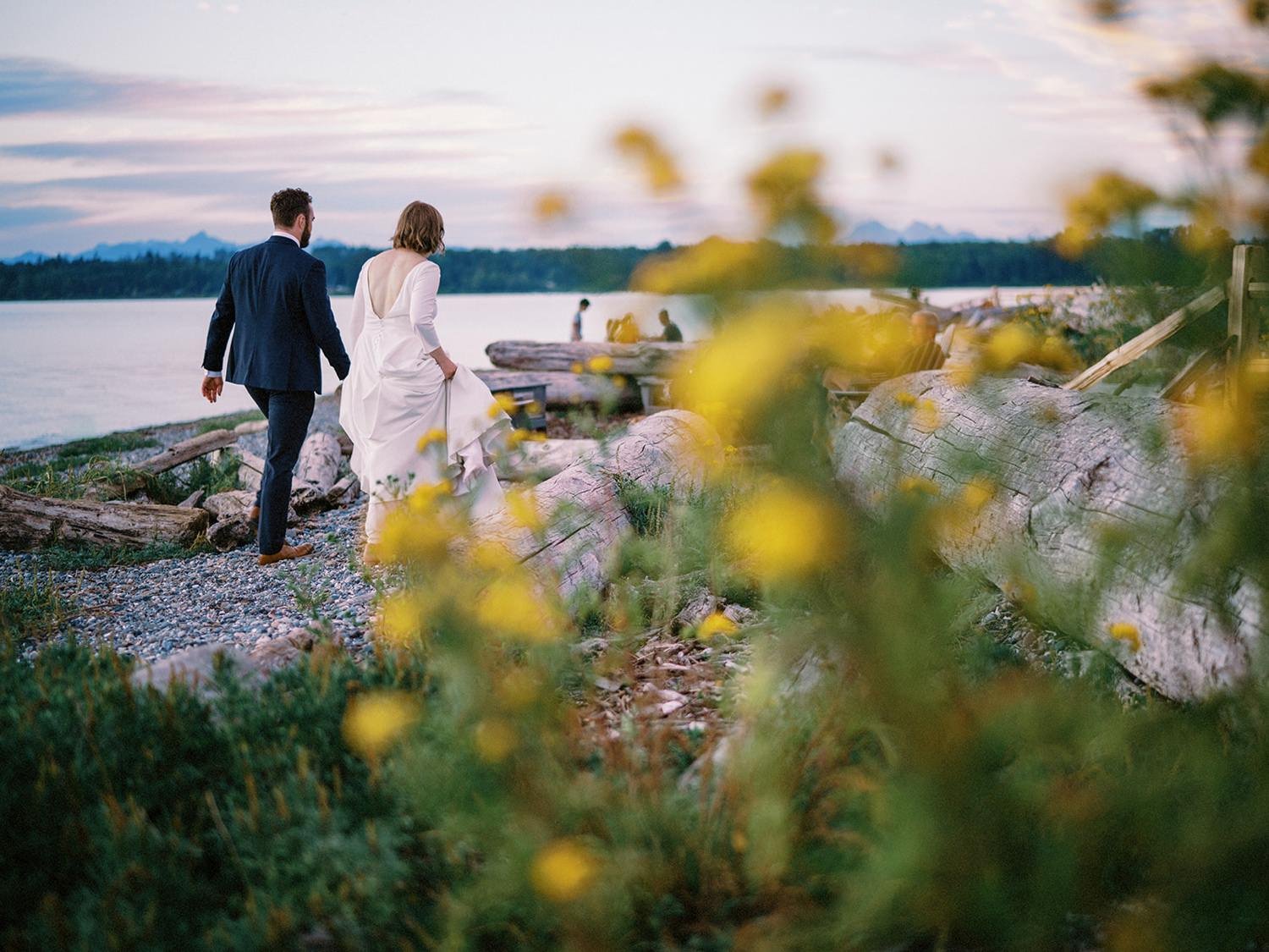 030_couple walking along the beach at Semiahmoo Resort during a wedding.jpg