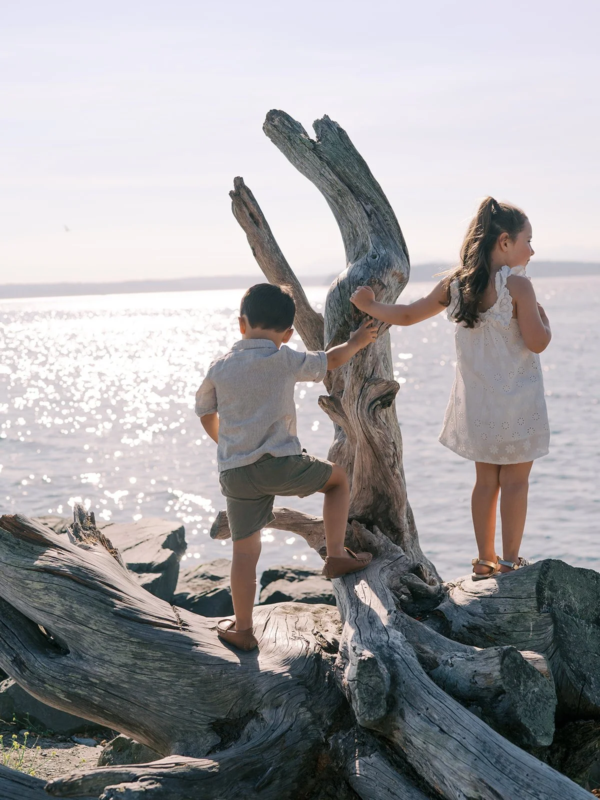 a candid documentary style family portrait of kids on the beach in West Seattle by Seattle Family photographer Ryan Flynn