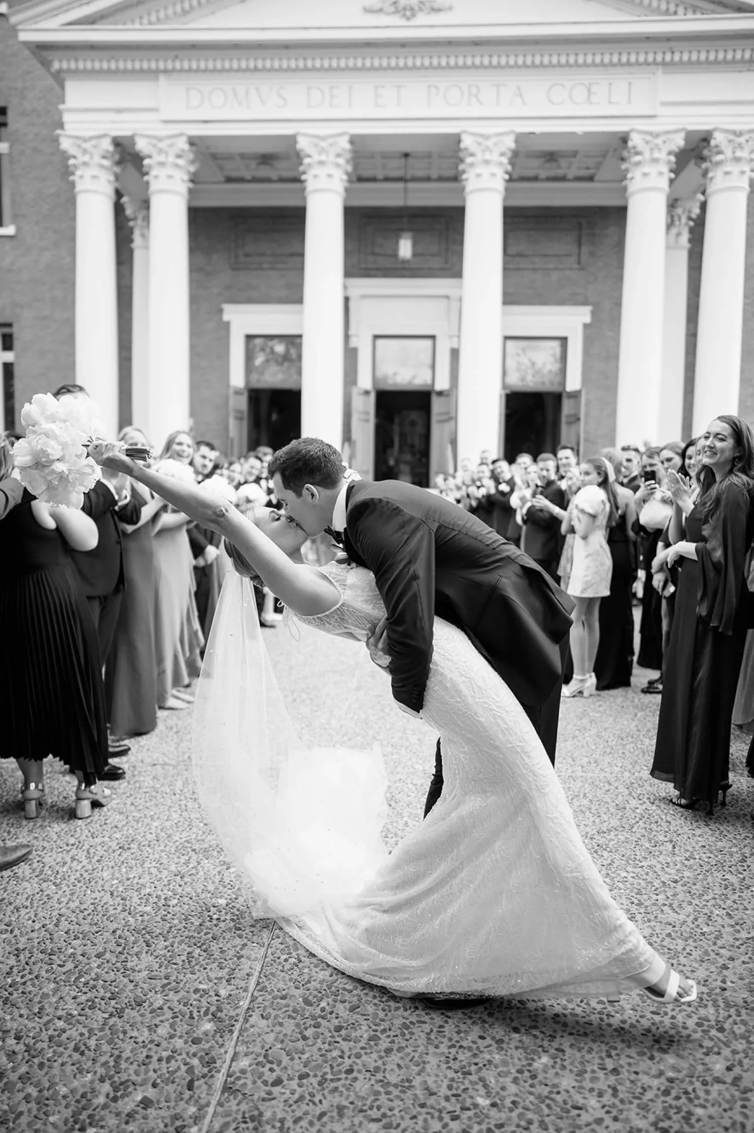 Bride being dipped by groom after wedding ceremony