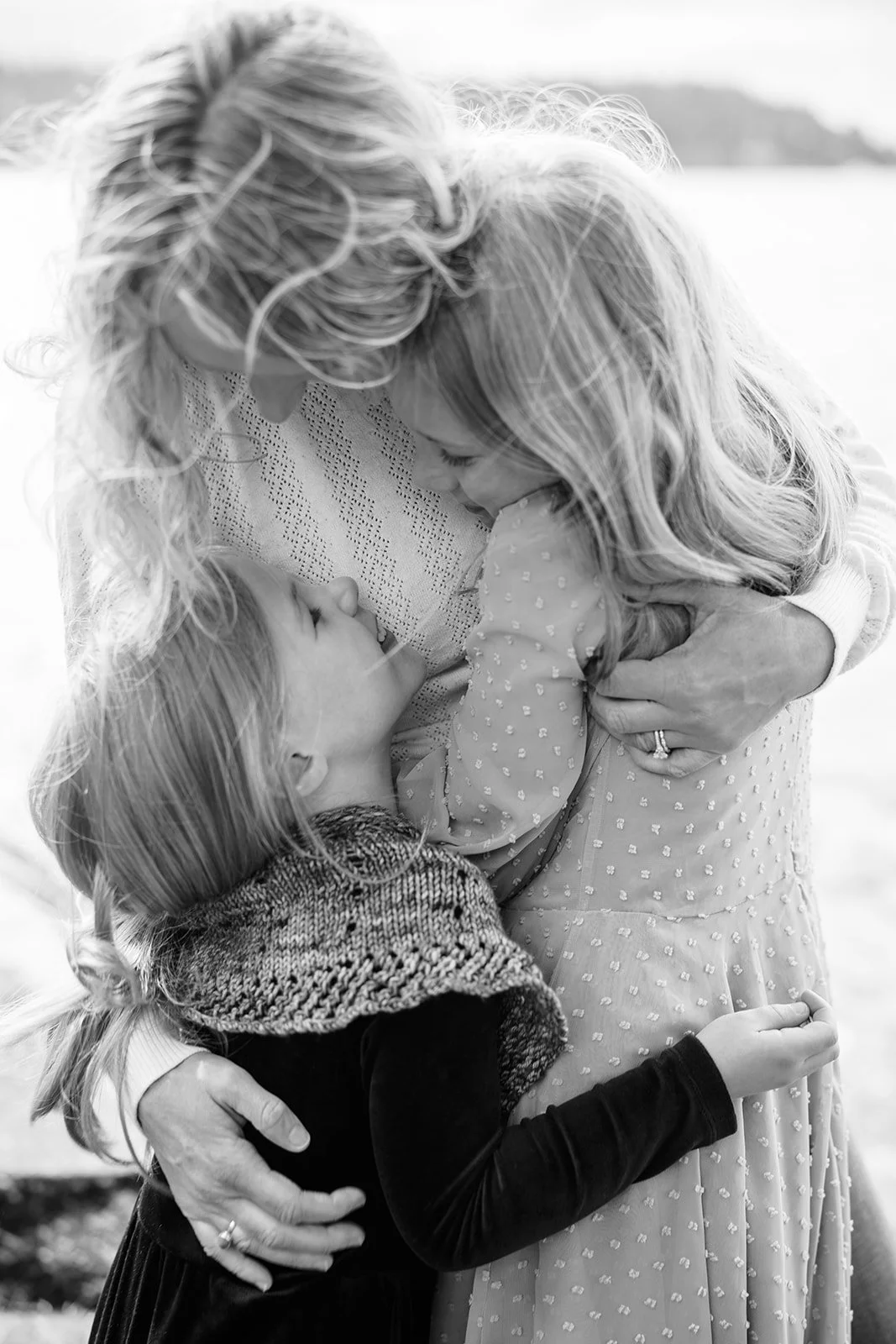 a family photo with a mom and daughters at Seward Park in Seattle by Seattle Family photographer Ryan Flynn