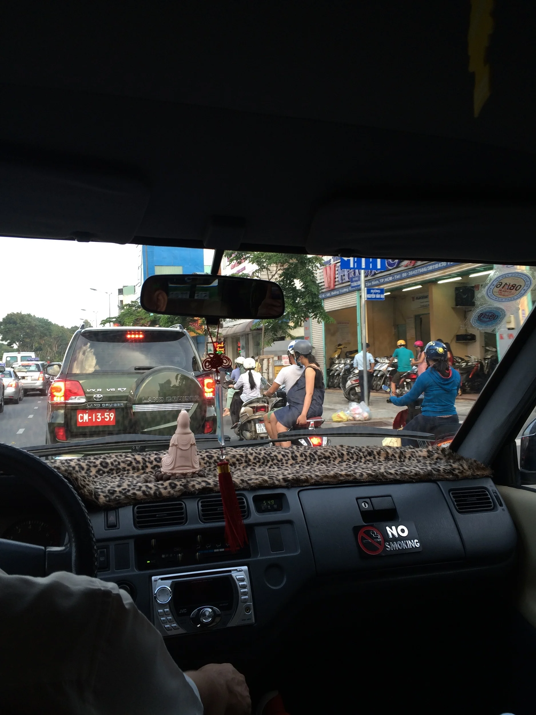 Inside of the taxi + pregnant lady side saddle on scooter!