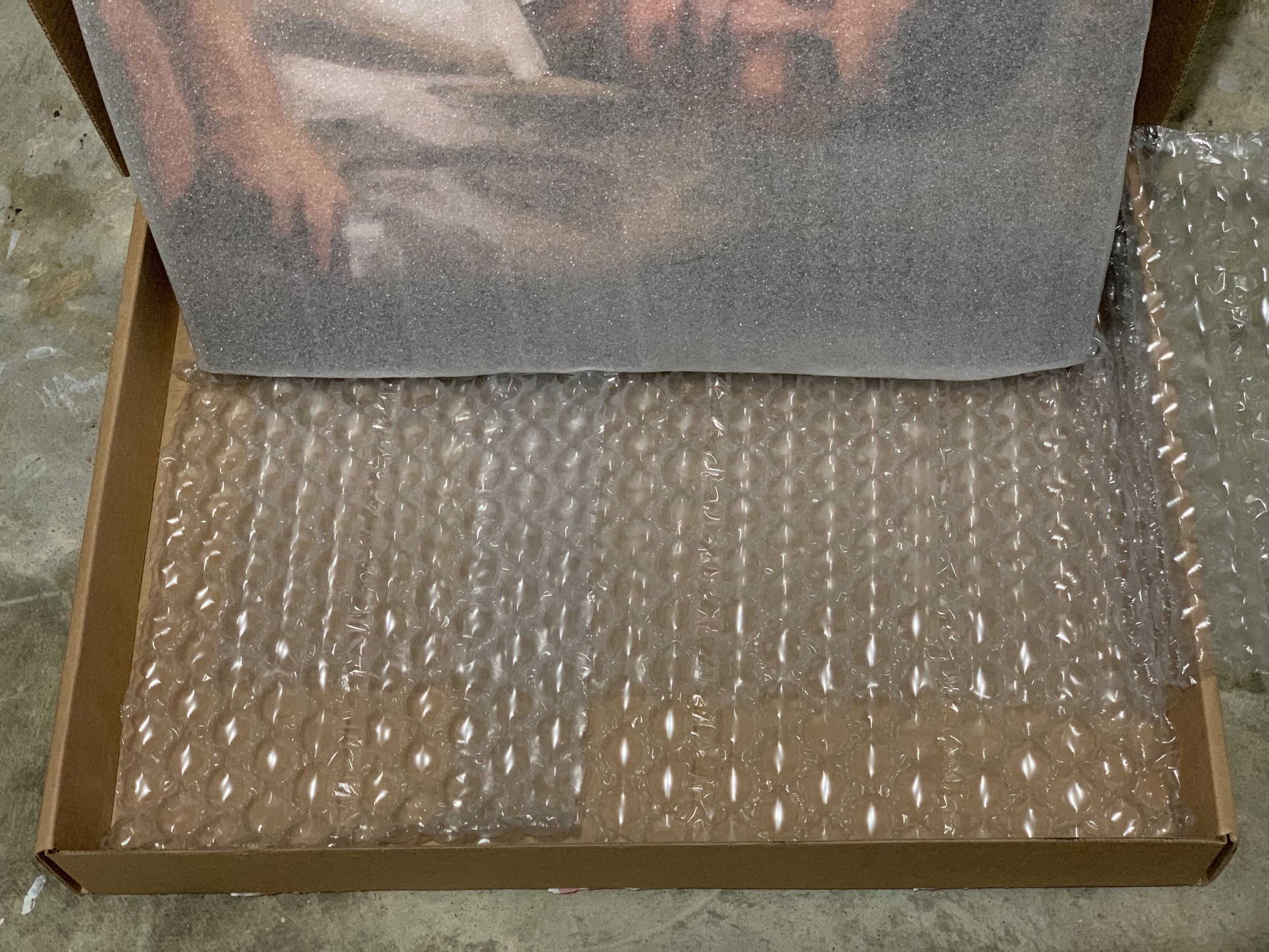 Front of print is protected in packaging with two bubble wrap inserts