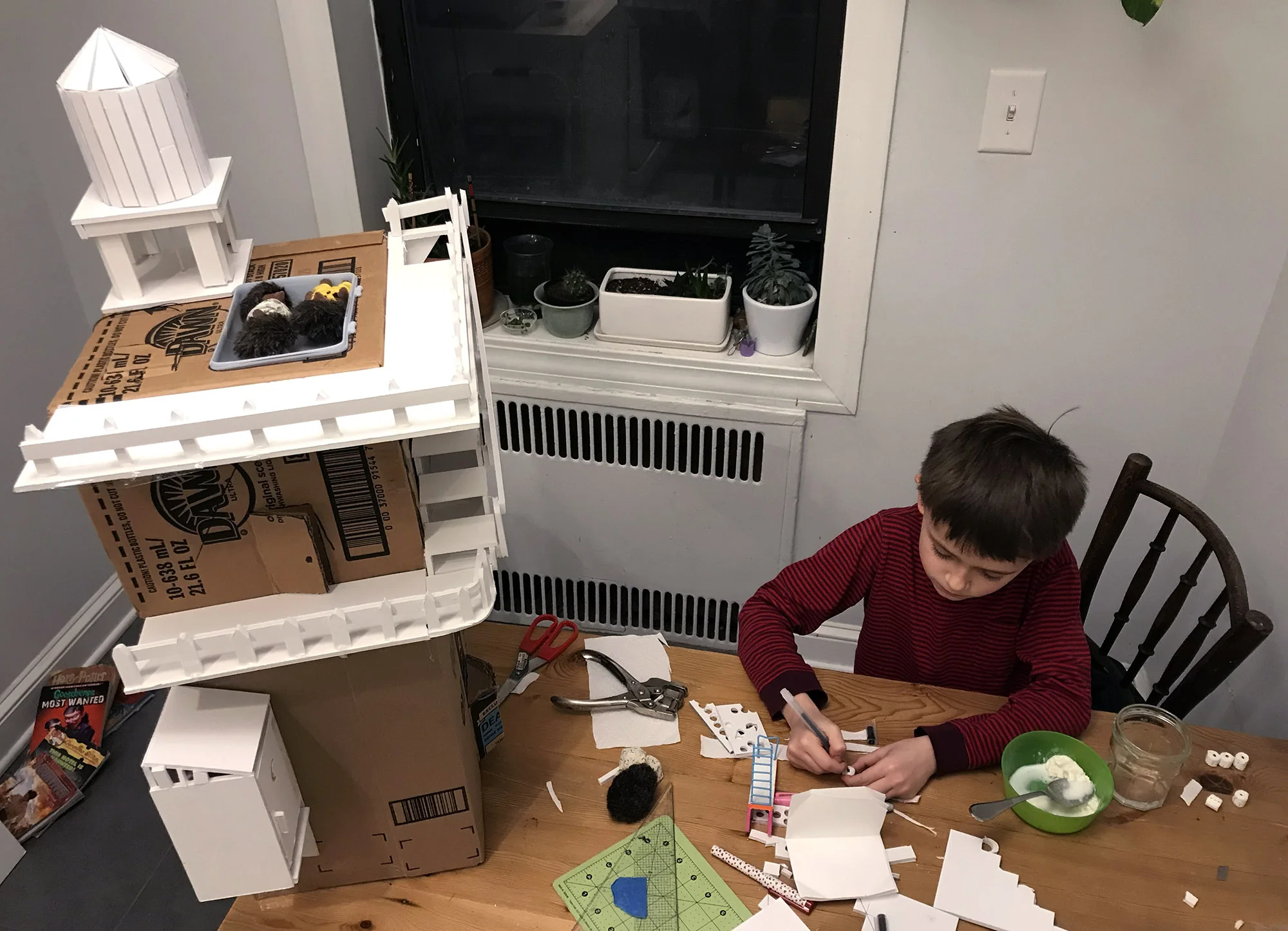 Willy busily making tiny toilet paper rolls for the outhouse.No workspace is complete without a small bowl of ice cream.