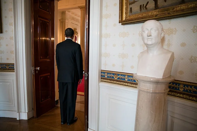 President Barack Obama waits as he is introduced for an event honoring the recipients of the 2011 National Medal of Science and National Medal of Technology and Innovation, in the Blue Room of the White House, Feb. 1, 2013. A bust of Christopher Columbus is seen at right. (Official White House Photo by Pete Souza)