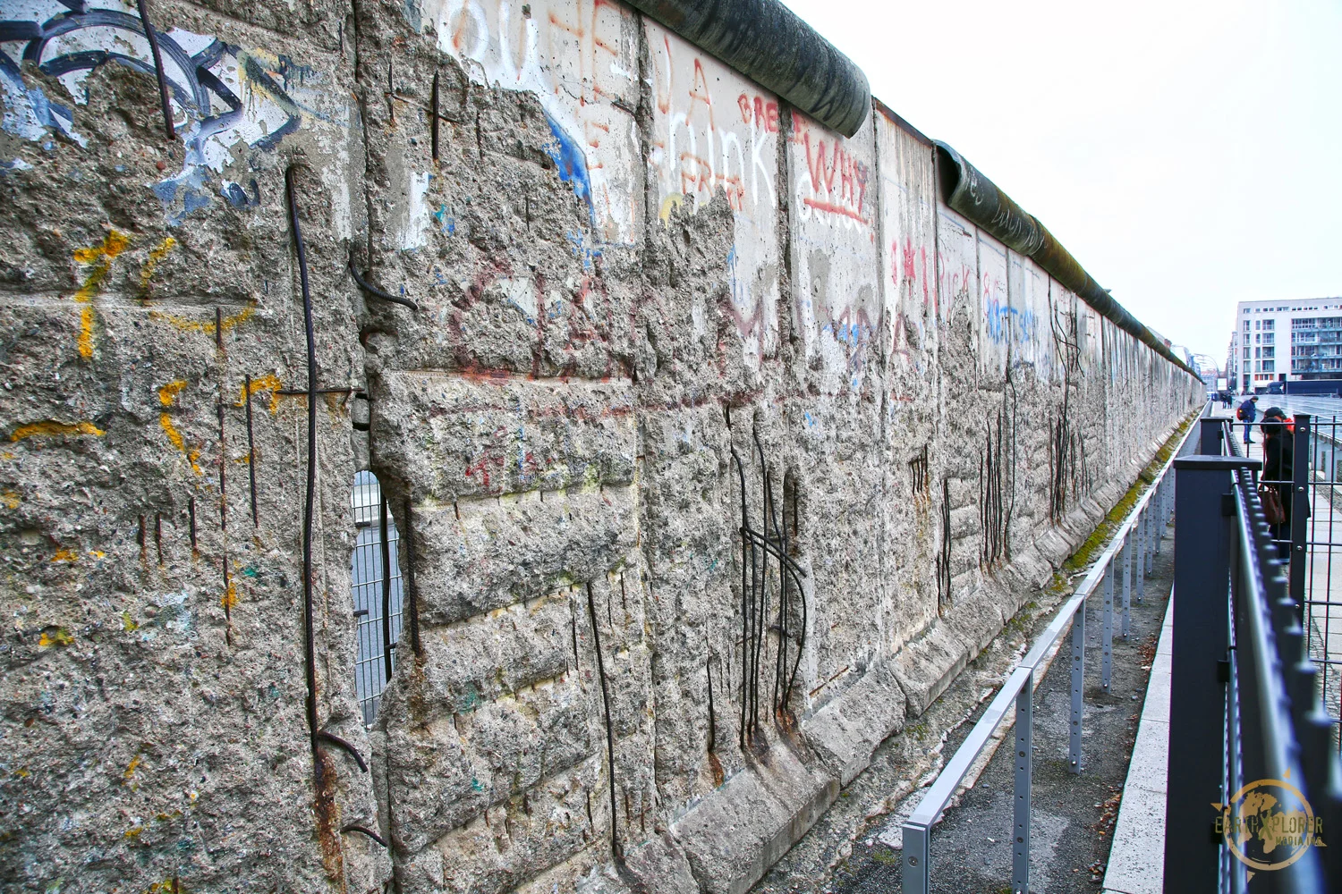 The Berlin Wall was a barrier constructed by the German Democratic Republic starting on August 13, 1961, that completely cut off West Berlin from surrounding East Germany and from East Berlin.
