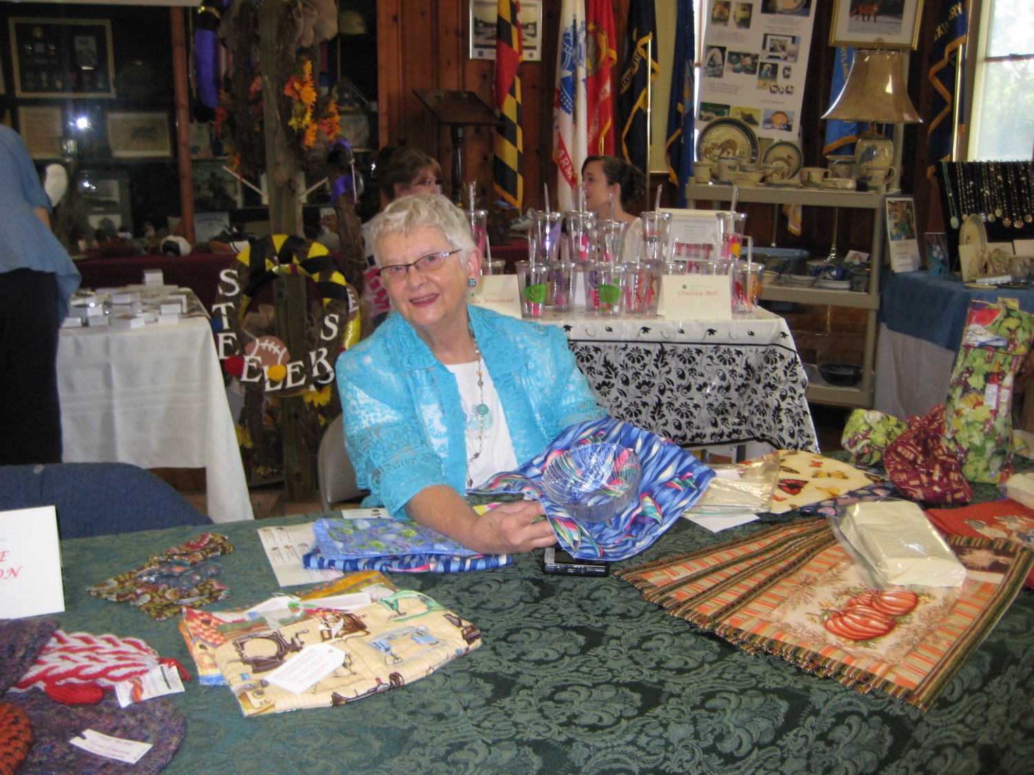  Alice Washburn displays knitted and quilted items, and she kept right on knitting throughout the Fair.  