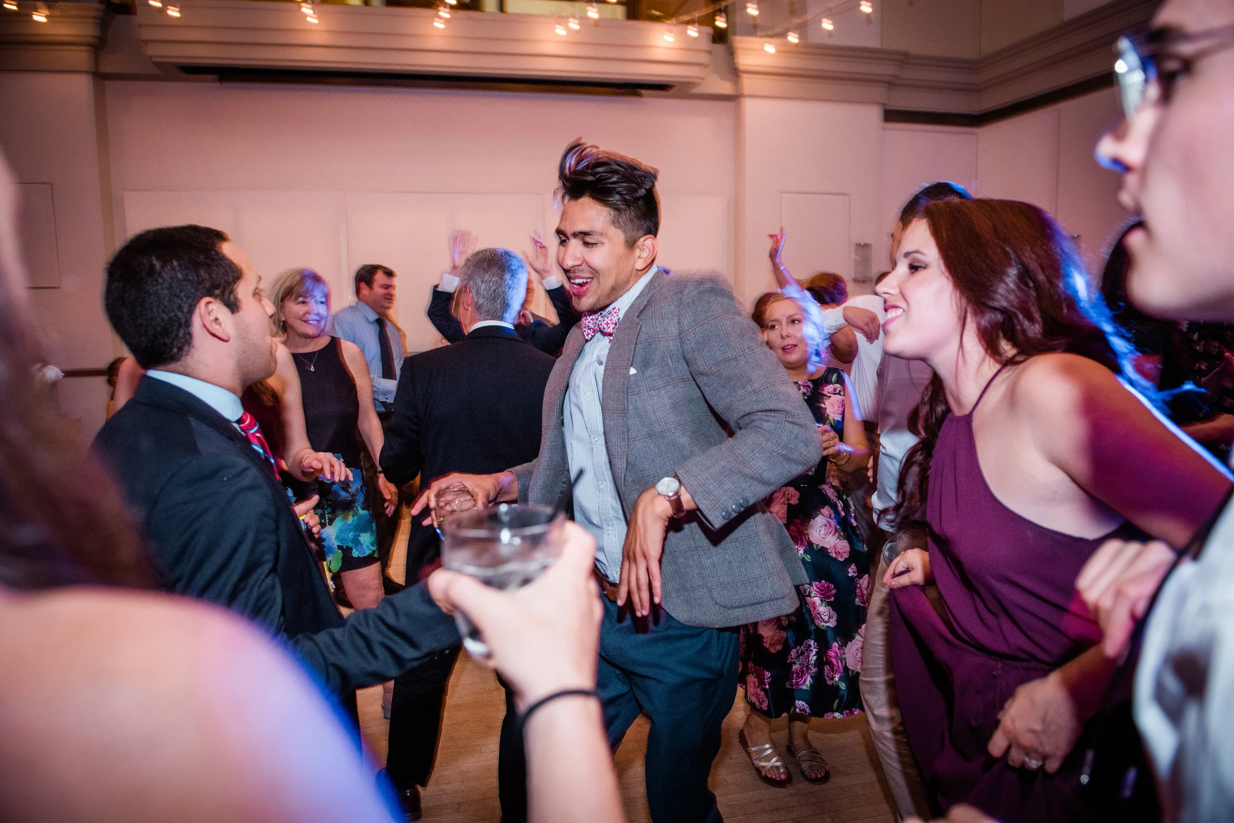 People dancing and socializing at a lively indoor party or celebration.