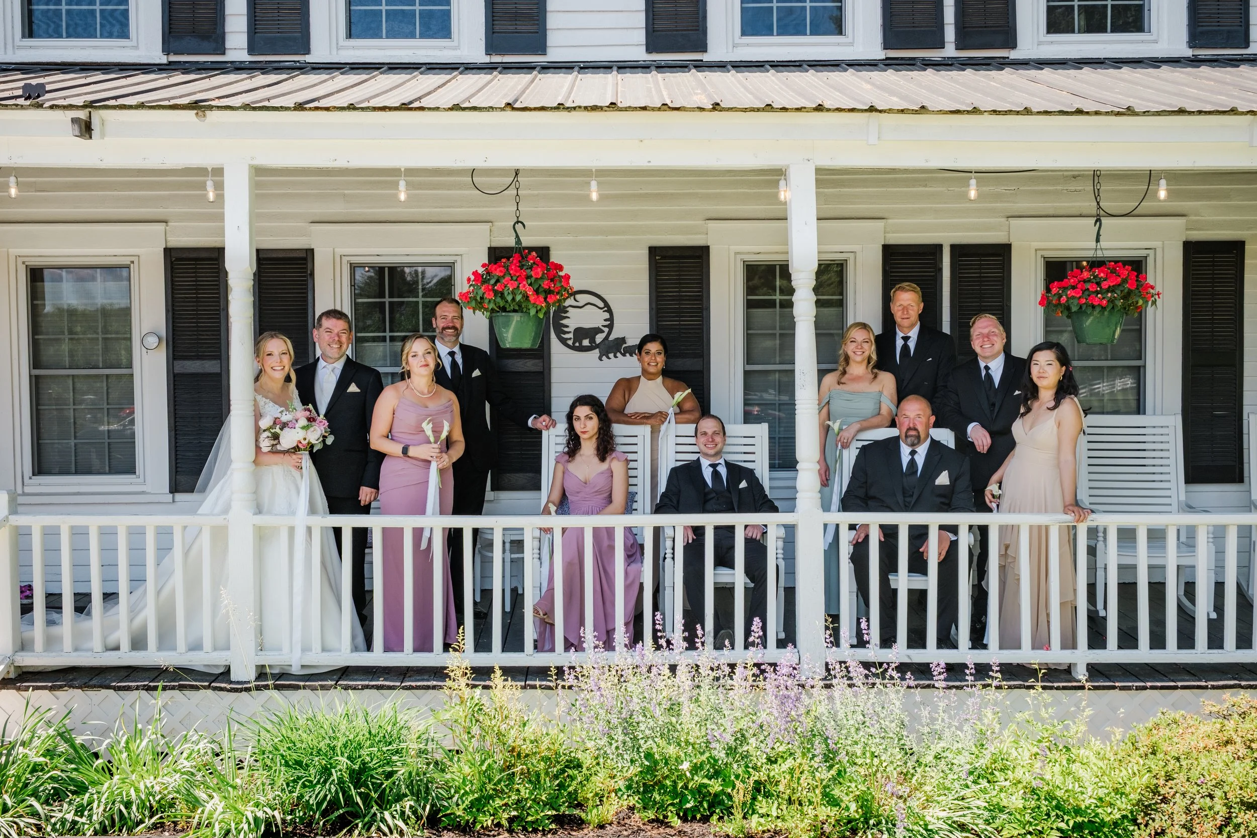 A group photo of a wedding party including the bride and groom at Bear Mountain Inn + Barn in Maine.