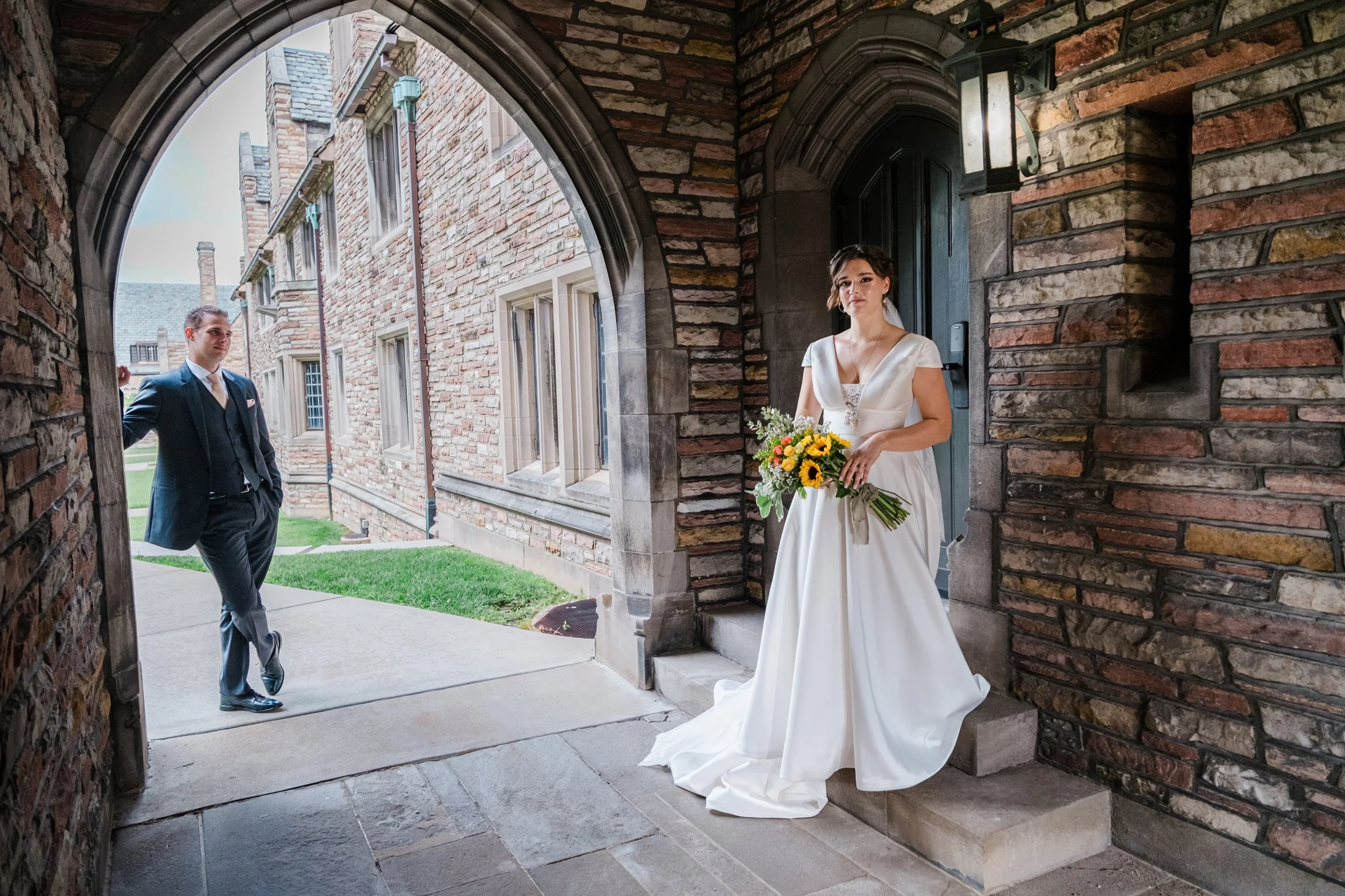 A groom looks at his bride at the campus of Concordia Seminary St. Louis during their wedding in Missouri.