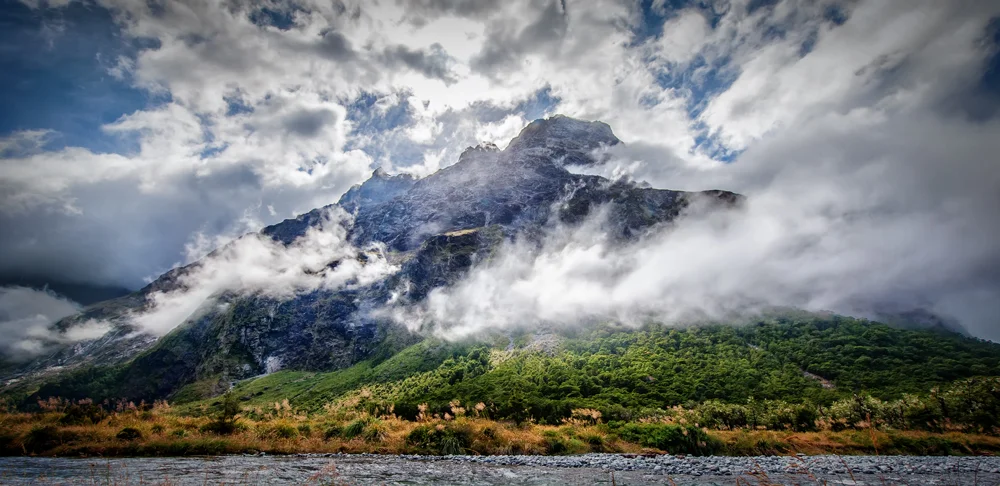 CLOUDS EMBRACE THE MOUNTAIN