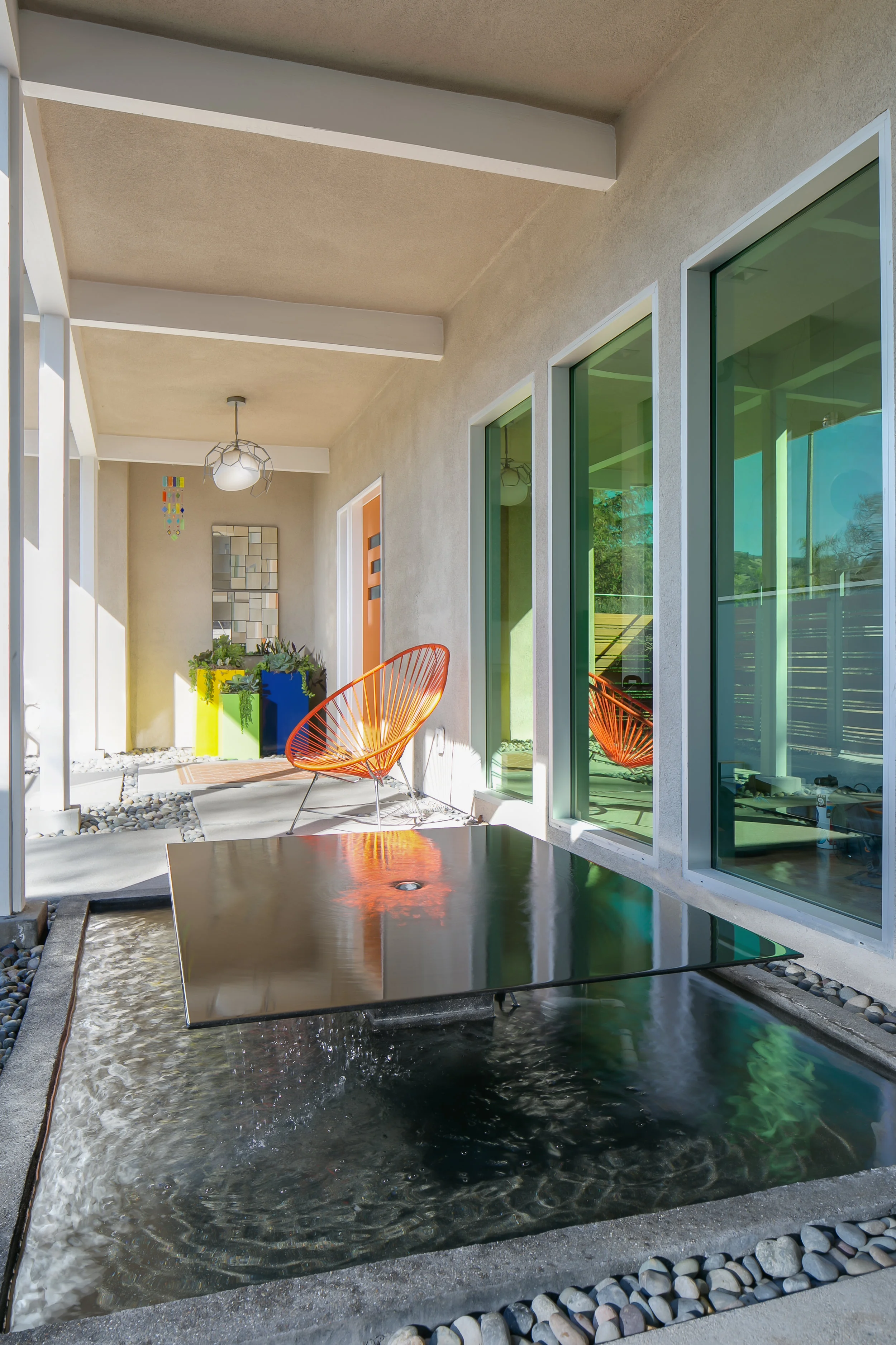 The water feature in the courtyard connects the inside and outside of the home