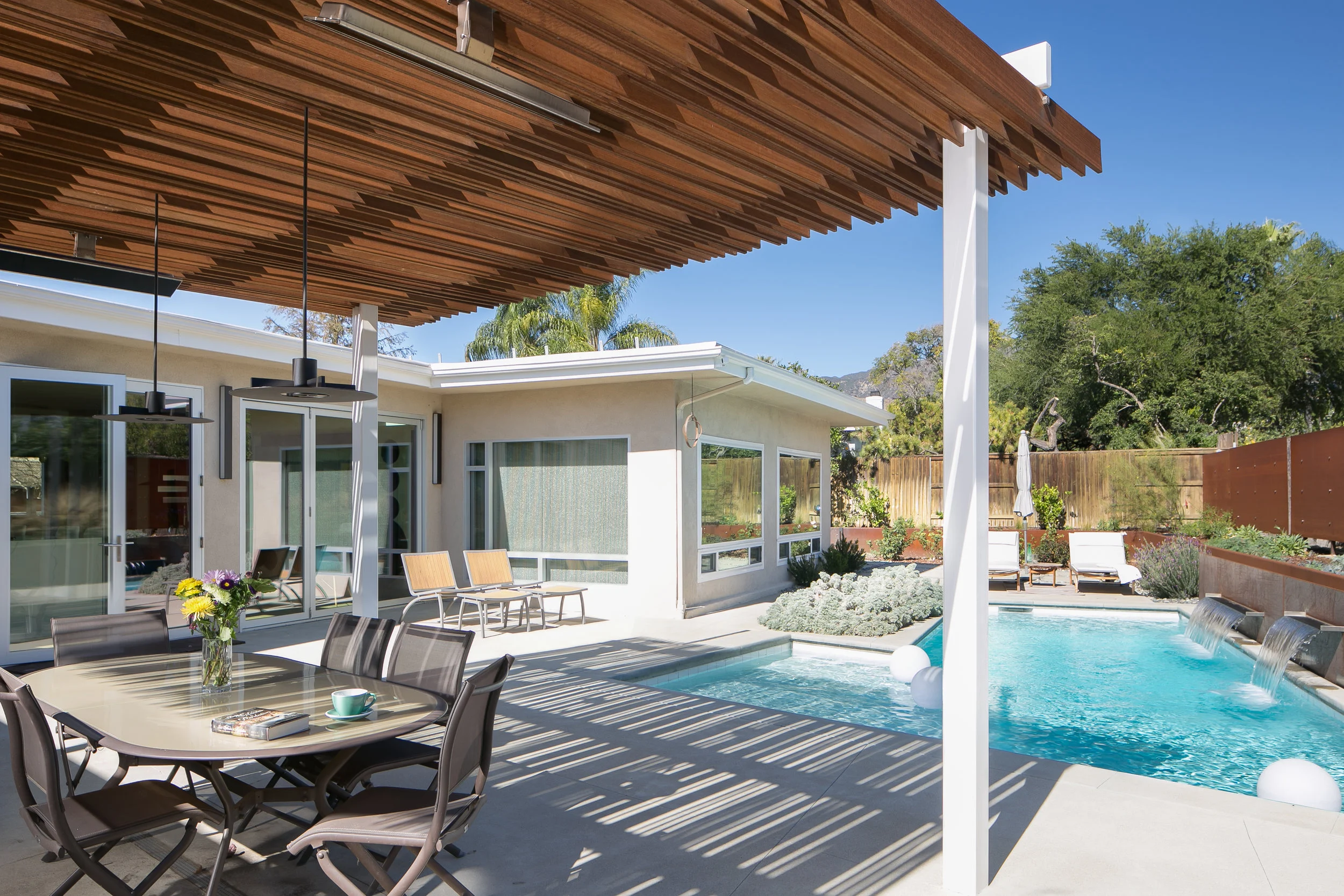 The backyard is zoned for different entertaining, each visually connected but discreetly separate