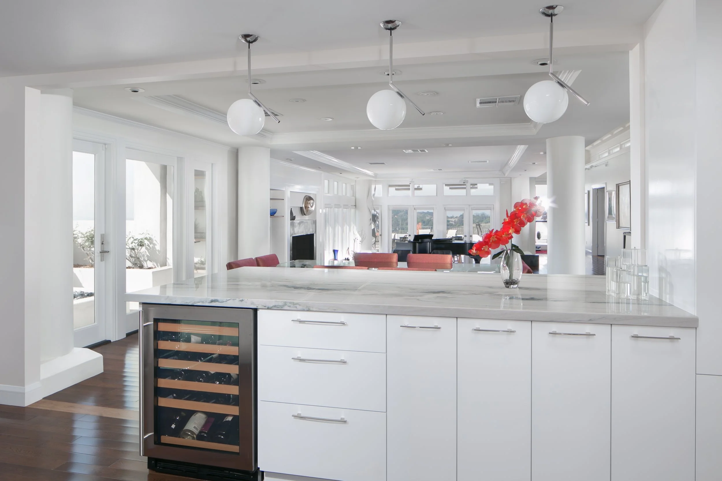 Enjoying the view from the kitchen peninsula thanks to the open floor plan and the abundance of patio doors and windows
