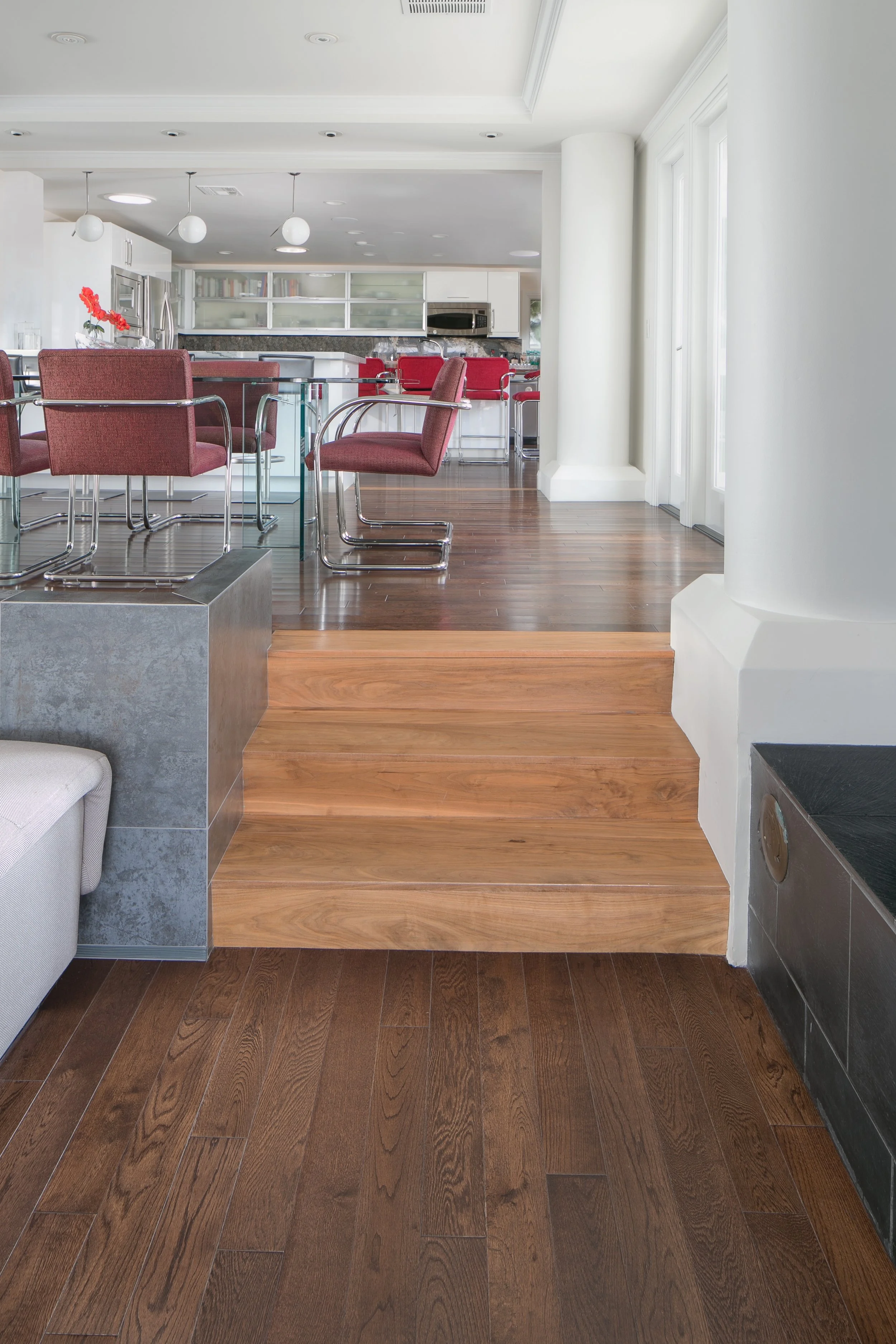 Post-modern remodel with open floor plan yet where each room is clearly marked: walnut accent against chestnut wood, tile wall, kitchen peninsula with bar seating