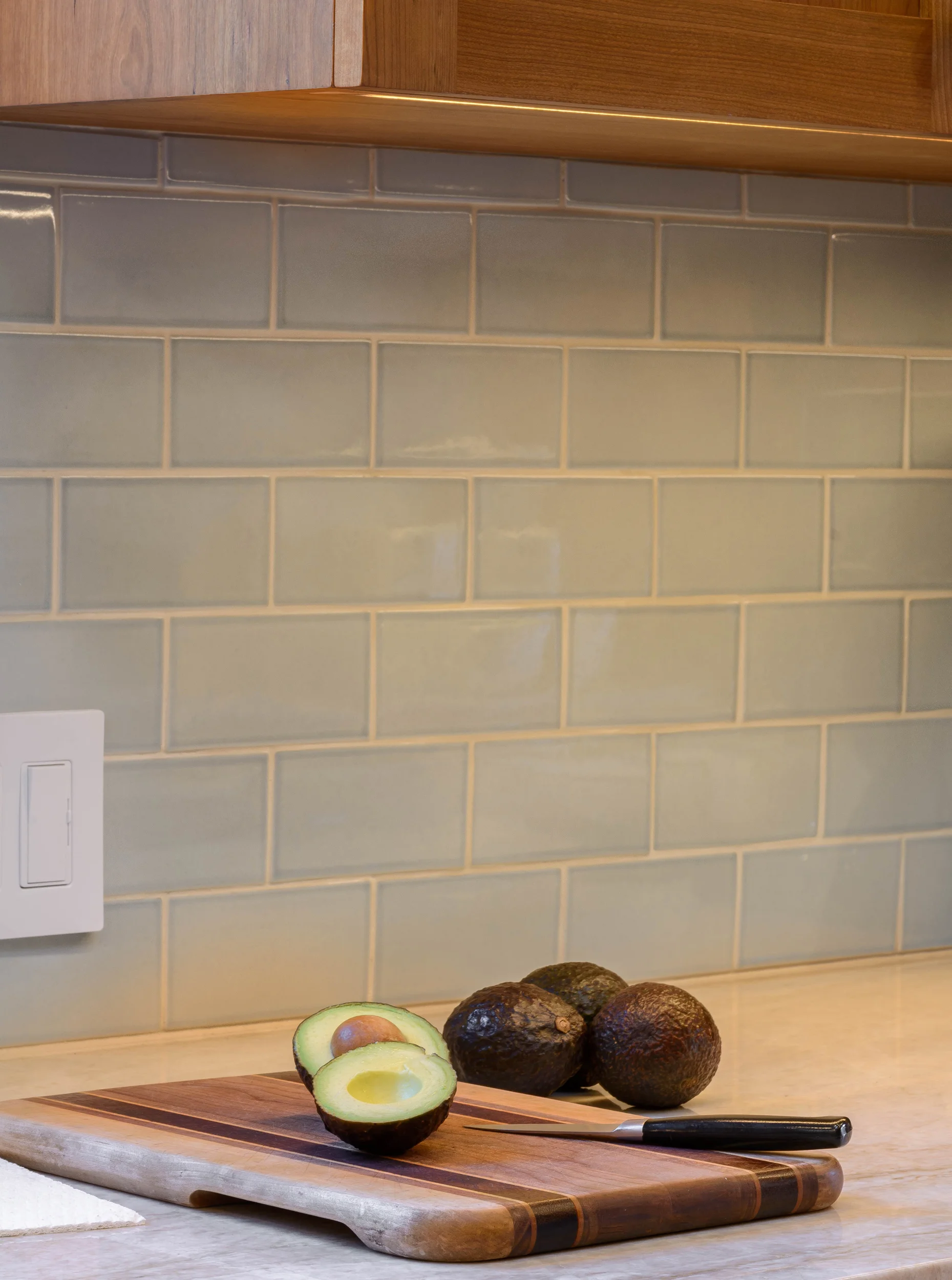 Kitchen stone counter with warm soft blue tile backsplash