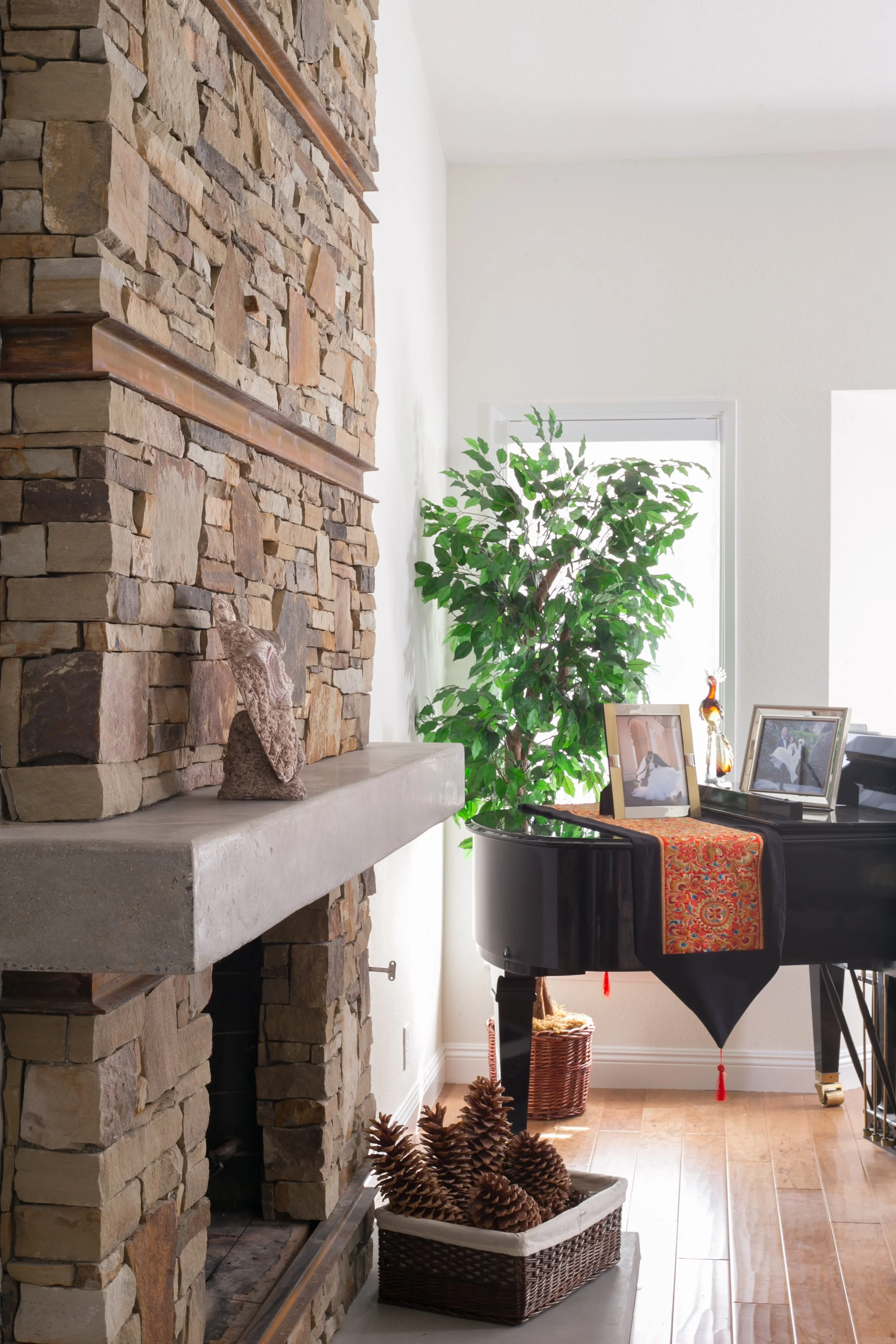 Extra warmth: stacked stone fireplace surround with rusted channels and a polished concrete mantel and hearth