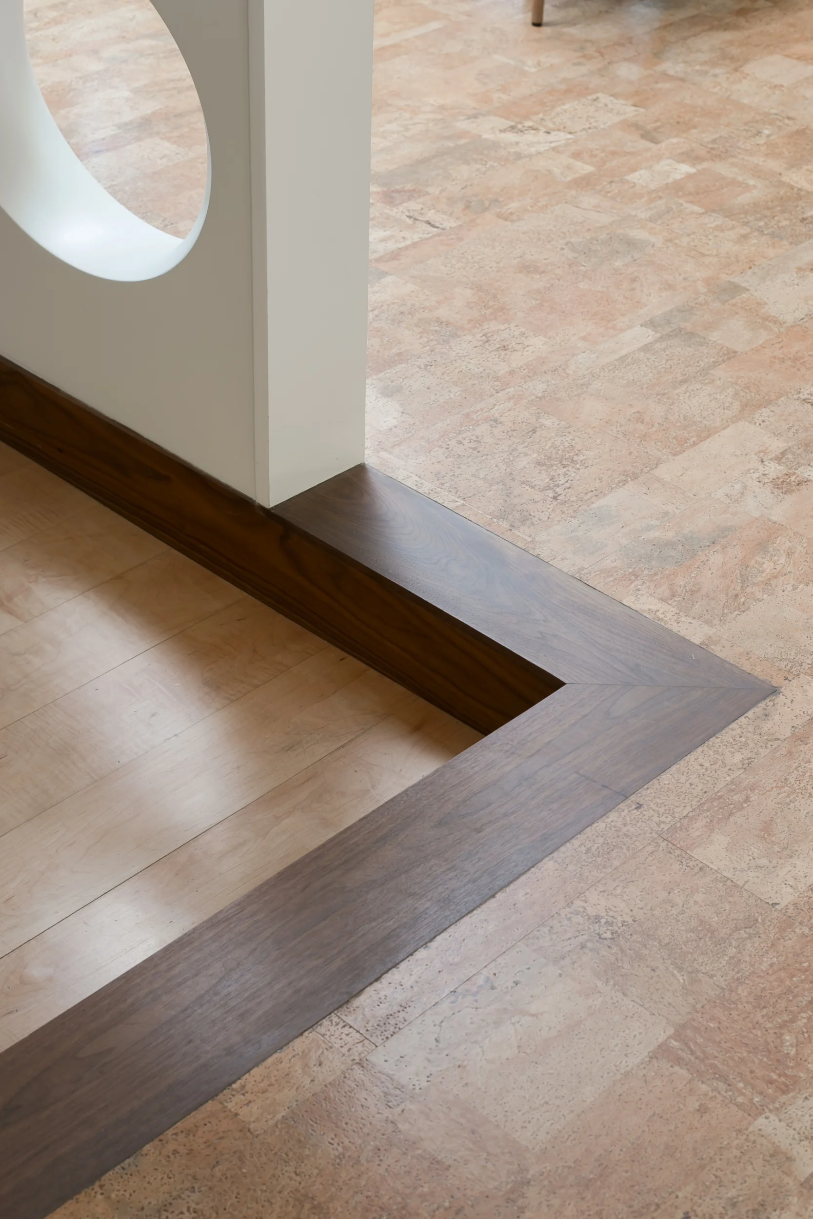 Walnut step between maple and cork floor for this mid-century modern remodel