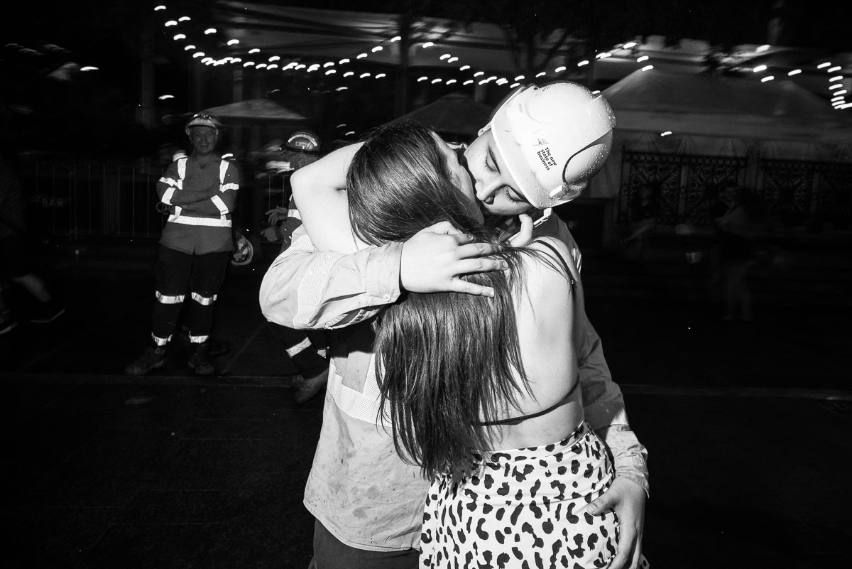  A construction worker steals a kiss at midnight. 