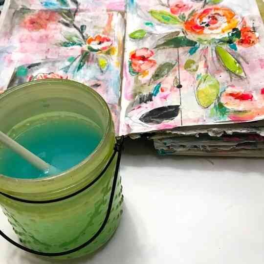 Green water jar with paint brush