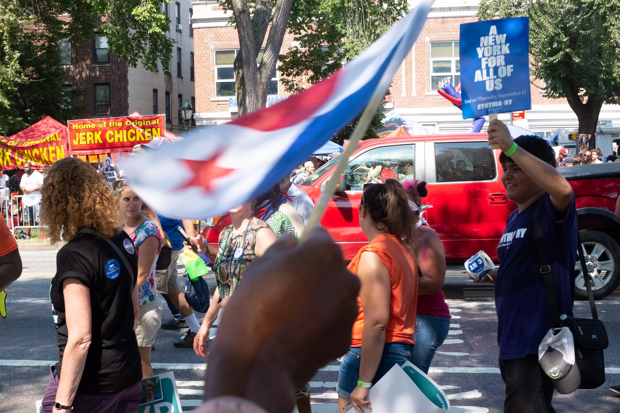 Perfectly obscured by this flag, is candidate for governor of New York, Cynthia Nixon