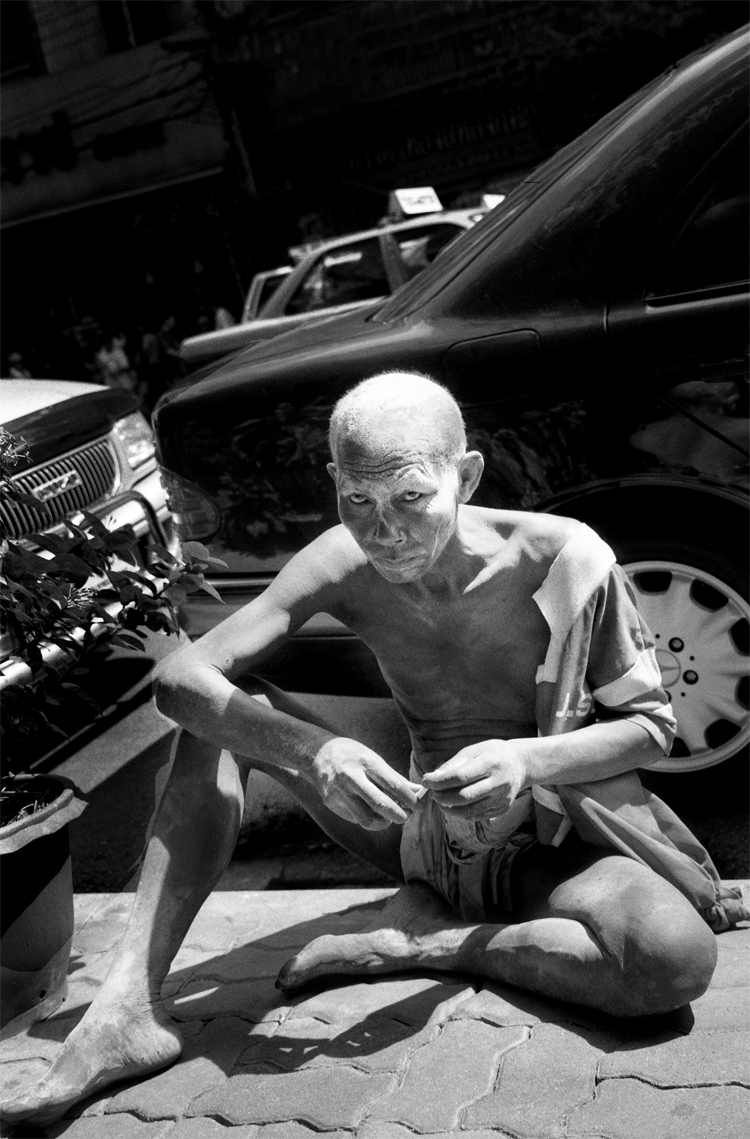 Beggar Beside The Mercedes benz