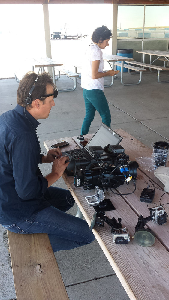 Clayton reviewing footage and writing copy (with producer, Kathy Nuestadt)