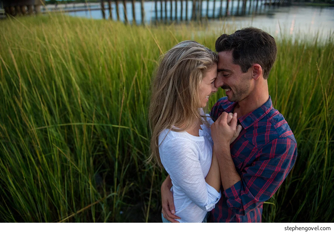 ocean city engagement photos sunset water beach boardwalk bikes marsh reflections