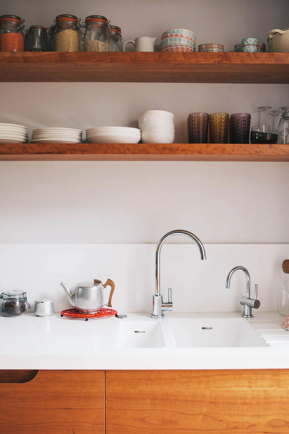 Floating shelves are also made with a cherry veneer to match the kitchen drawer fronts.