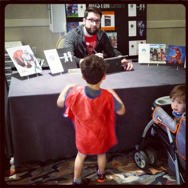Me at my booth with my sad art display and my homemade sign. My two boys were into it.