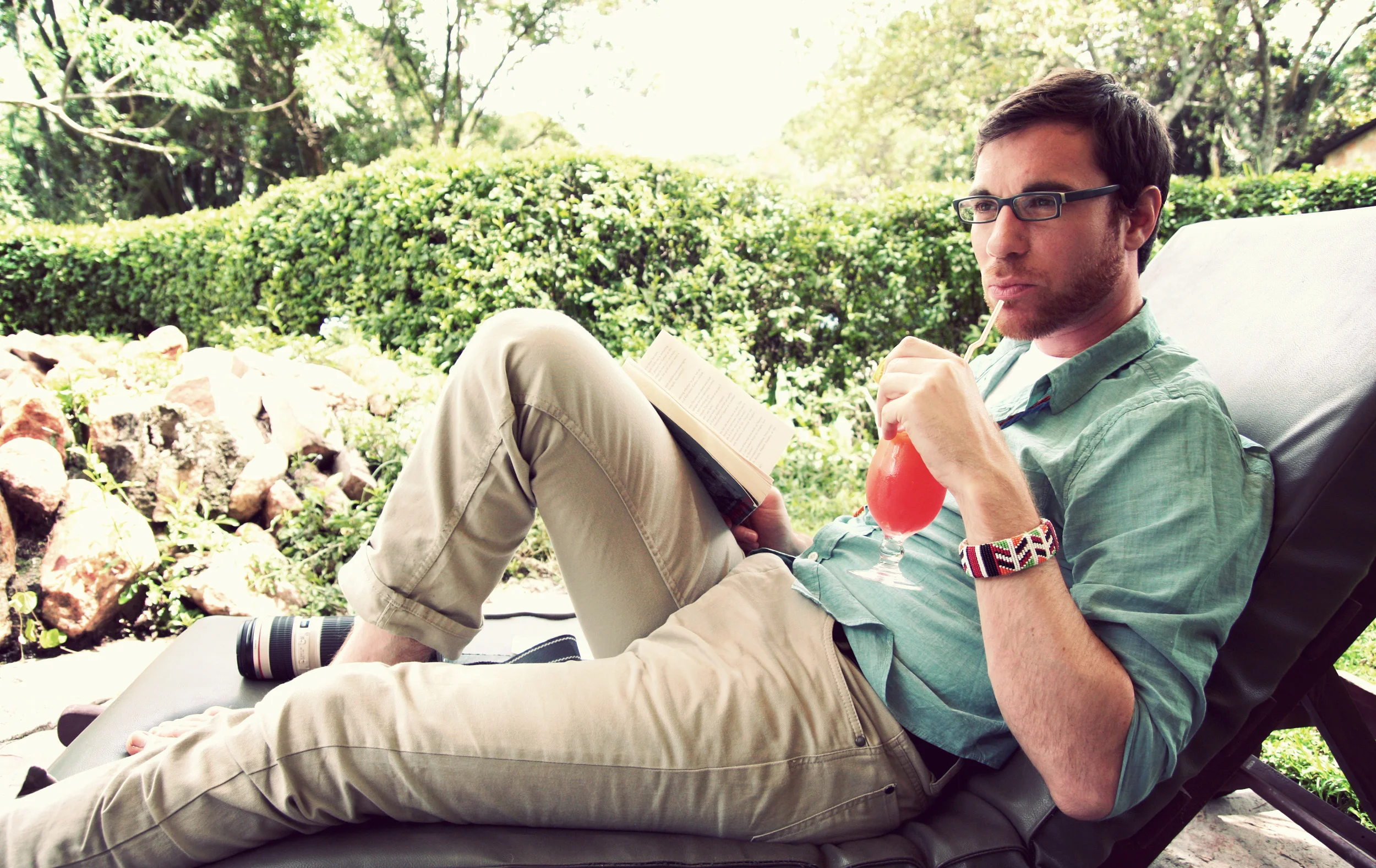 Jed is modelling the latest H&M safari fashions, sporting a traditional Maasai bracelet and enjoying an extremely unmanly afternoon cocktail.