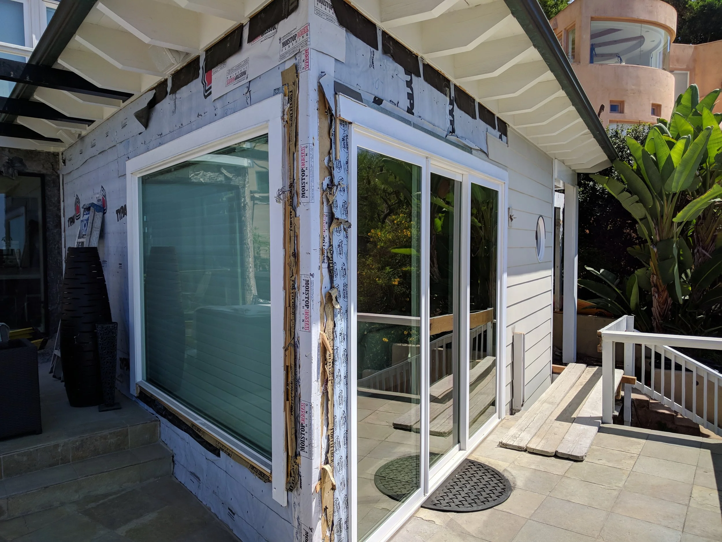 This door and window will be replaced by folding doors. The current 9 foot sliding door will be replaced with a 18 foot folding door. The entire front of the residence will be a glass wall.