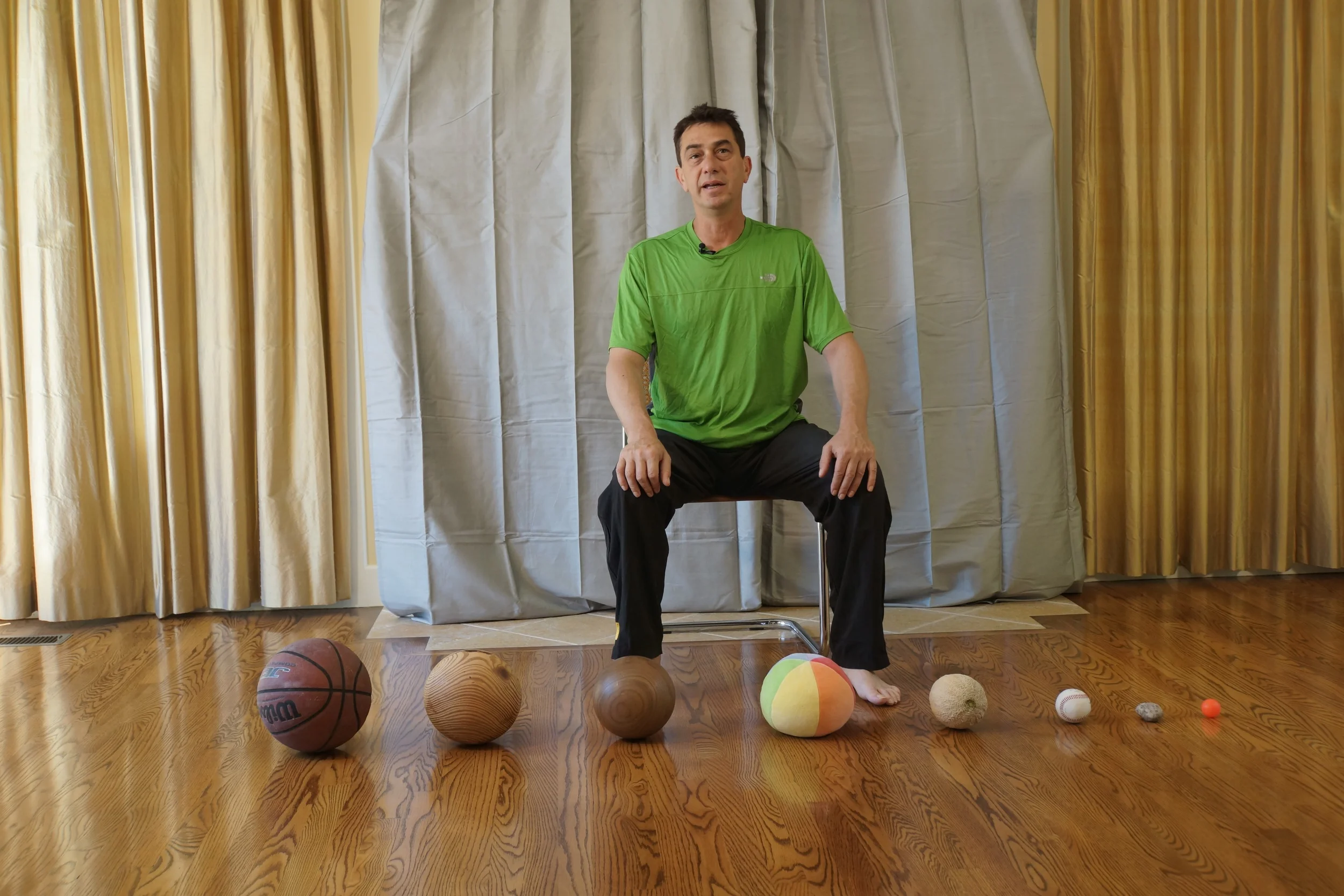 Rami Sitting with round objects.jpg
