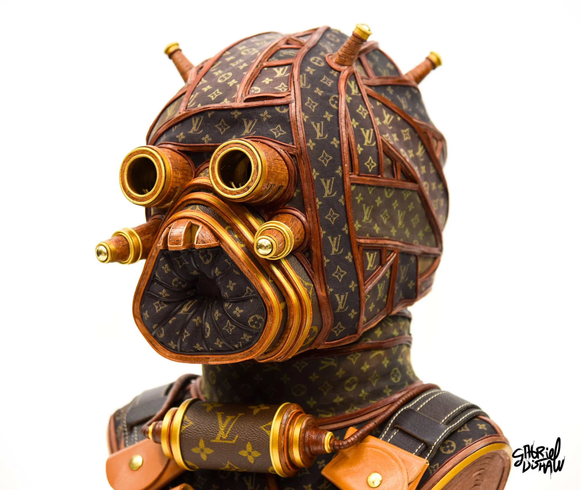 Wearable Tusken Raider helmet sculpture made from upcycled Louis Vuitton monogram canvas, leather straps, and brass hardware by Gabriel Dishaw