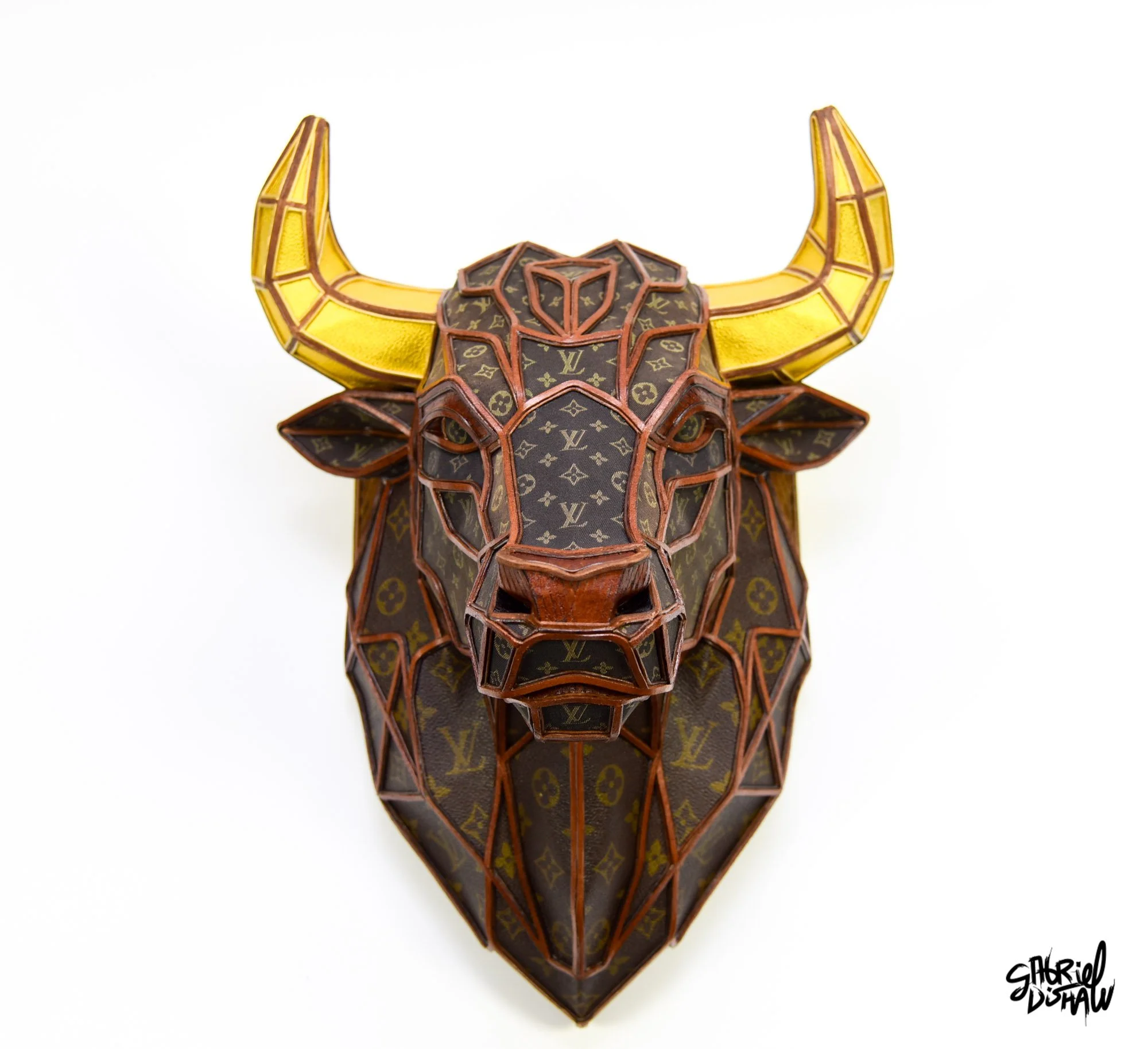 Bullish by Gabriel Dishaw, a geometric low-poly bull mount made from upcycled vintage Louis Vuitton luggage and saddle bags with gold leather horns and leather trim