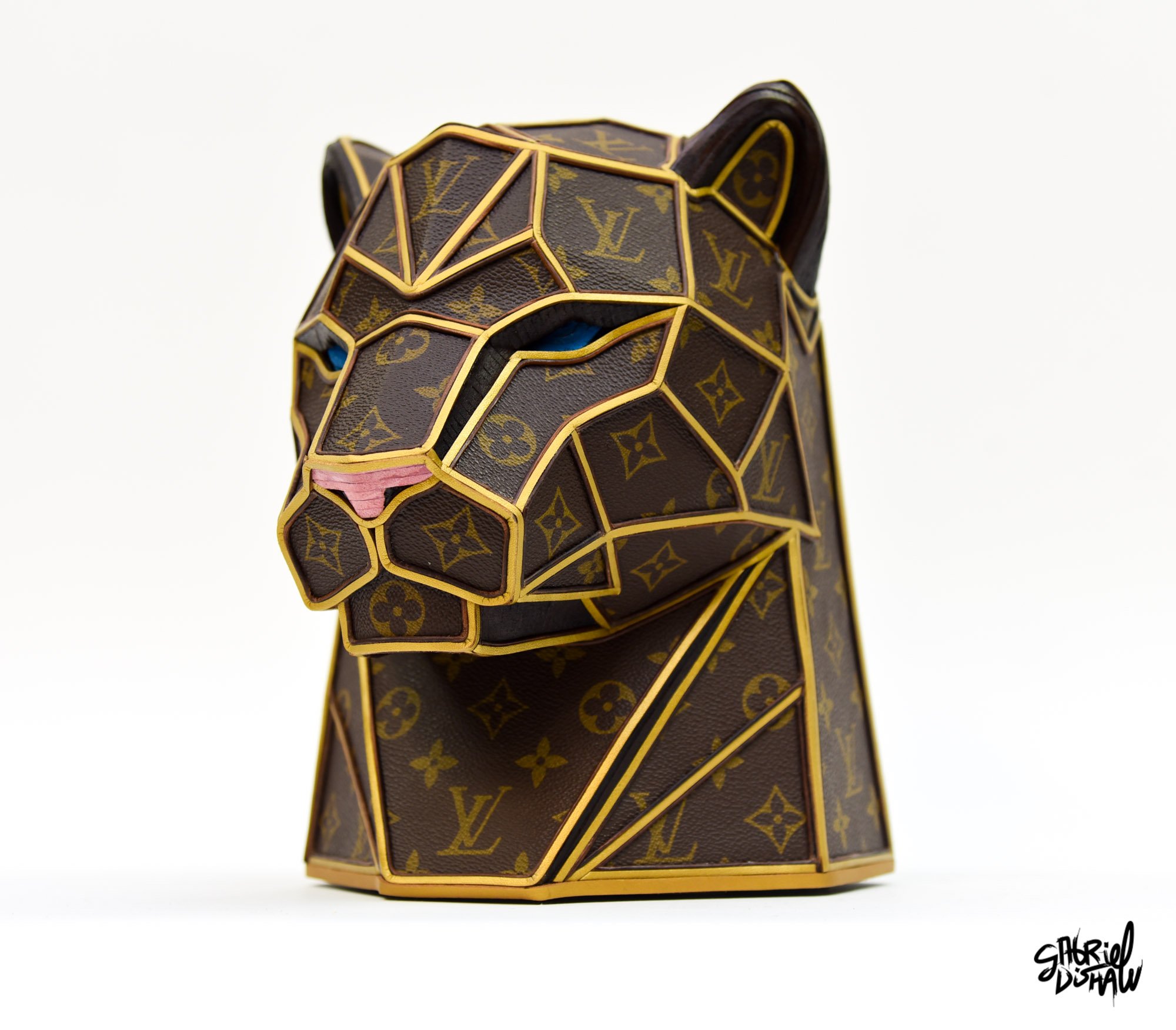 Panther Luxe, a geometric low-poly panther bust made from upcycled vintage Louis Vuitton monogram canvas with gold trim, leather seams, blue eyes, and a pink nose