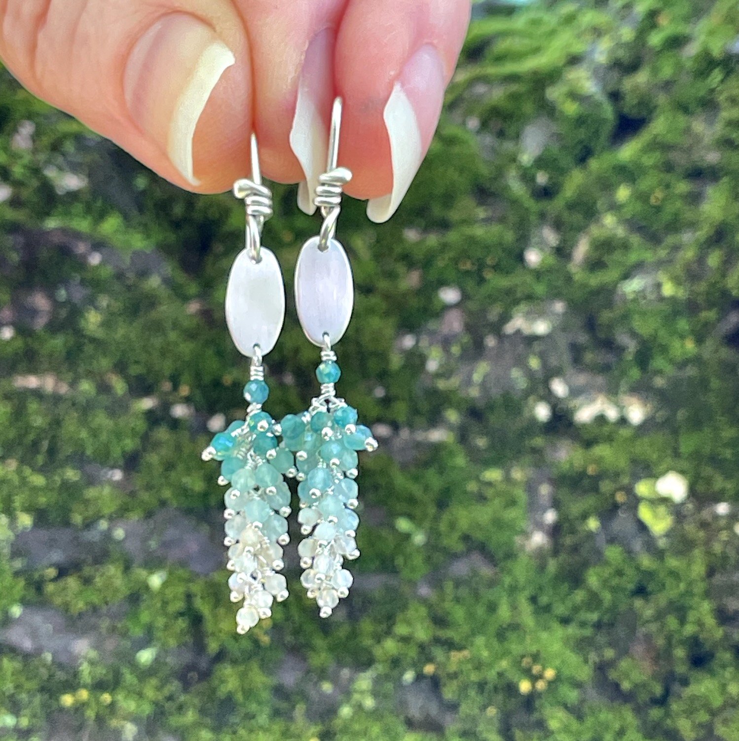 Sterling silver teal blue grandiderite and off white opal gemstone dangle earrings.