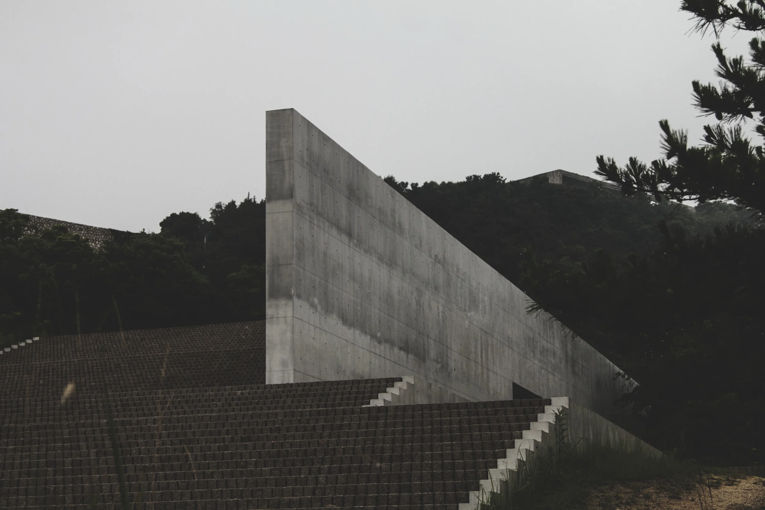 Benesse House Walter de Maria Pavilion near the water - Tadao Ando. (edge of the Benesse House seen on top of the hill to the left of frame, the hotel extension, the Oval, edge seen on the top of the hill to the right) 