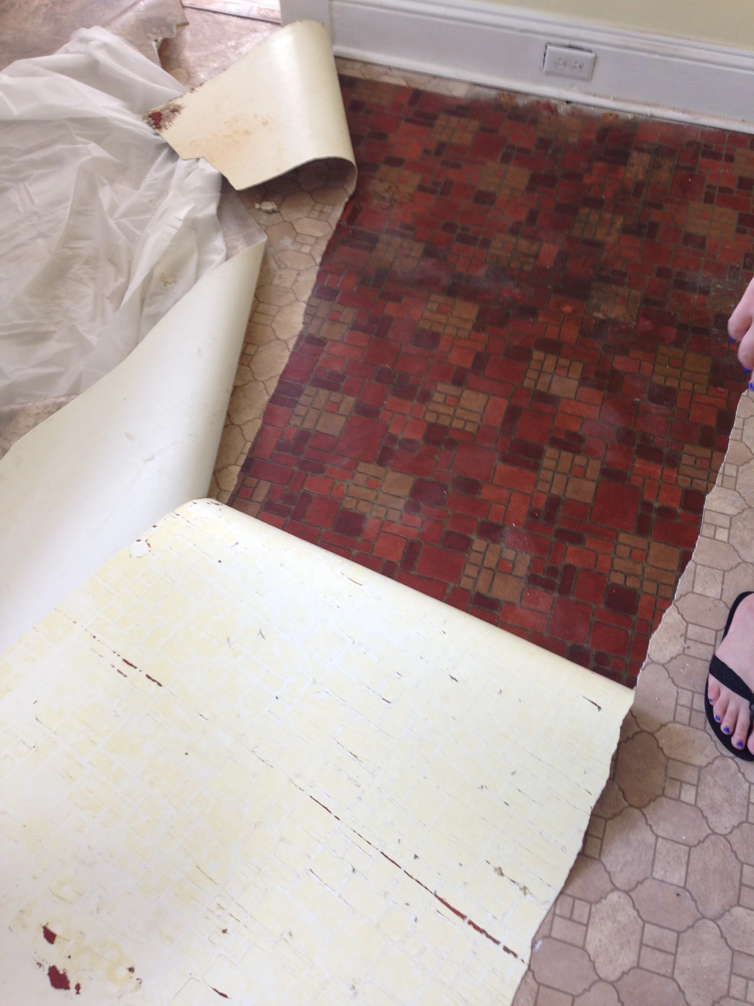 Told you it was hideous!! Some of the vinyl came right up since it had originally been glued. The last layer was stapled down to within an inch of its life and gave us quite the runaround! 