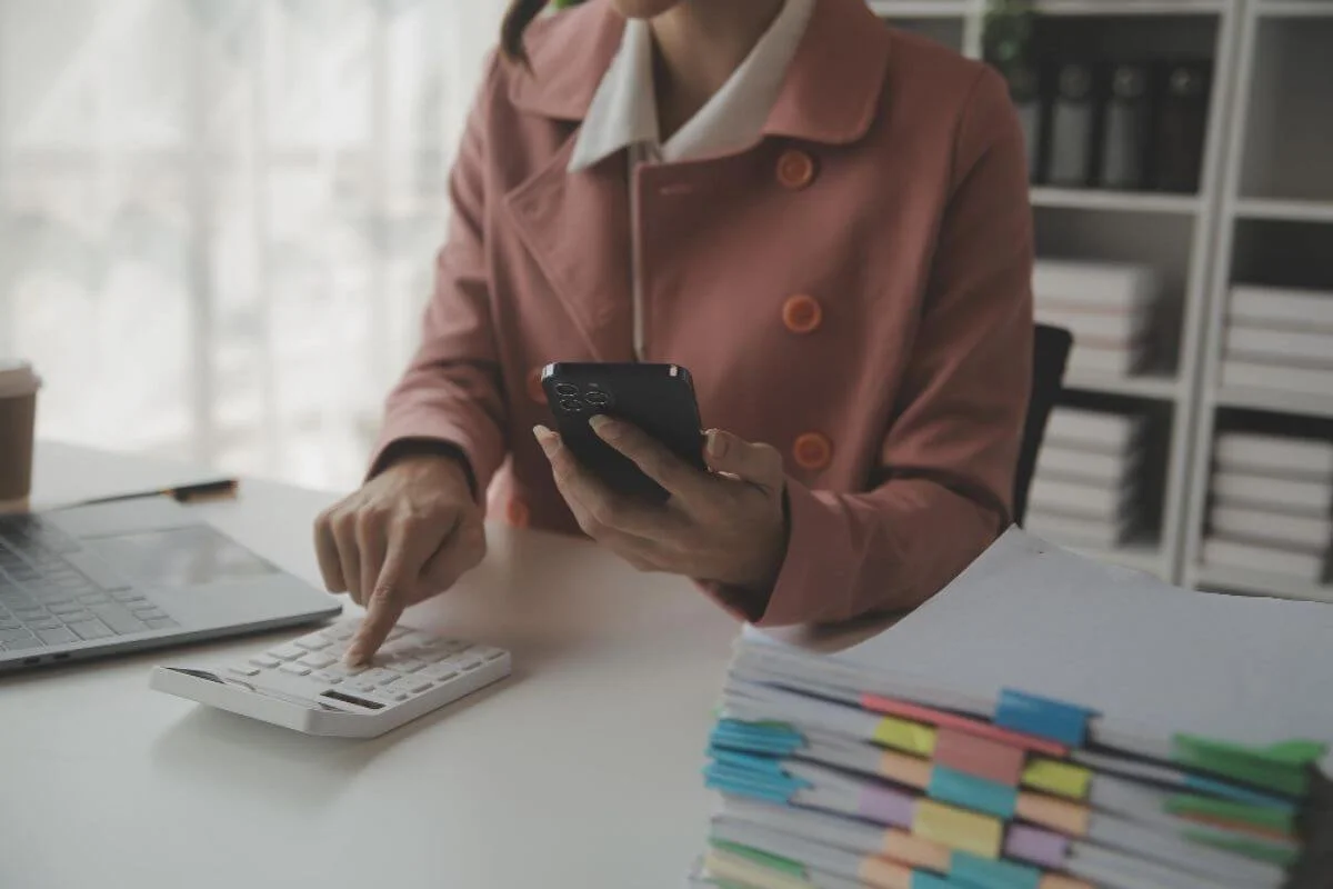Person overwhelmed by manual expense tracking, spending excessive time cross-checking company records and financial data for accuracy.
