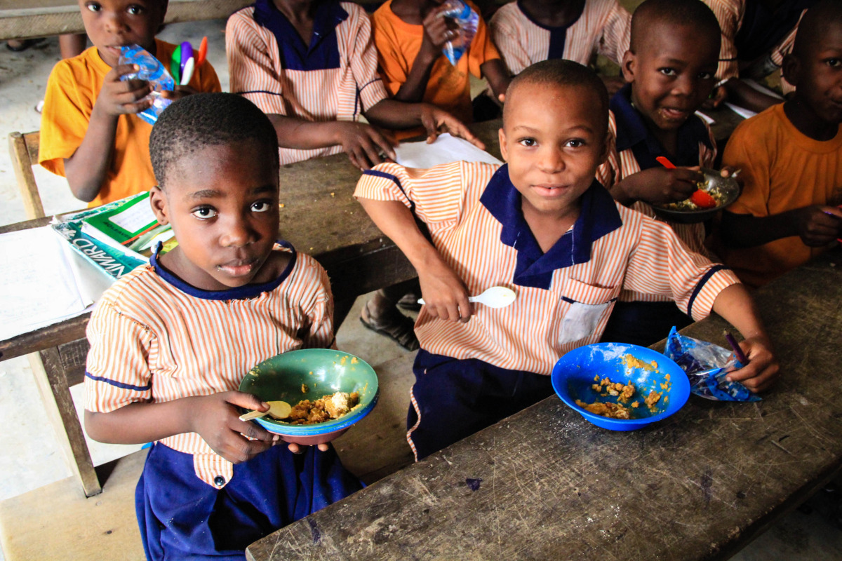   Children enjoying their hot, nutritious meal for the day in the community of Ilaje.  
