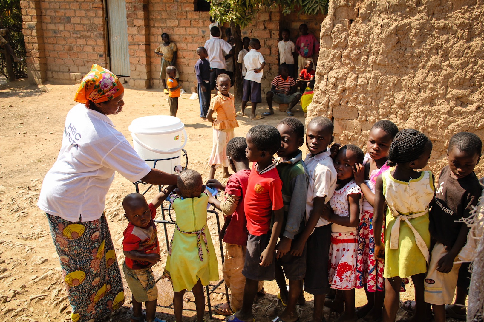 Some of the 75 most vulnerable children who are cared for in Kitabataba; washing their hands with the help of a loving Care Worker
