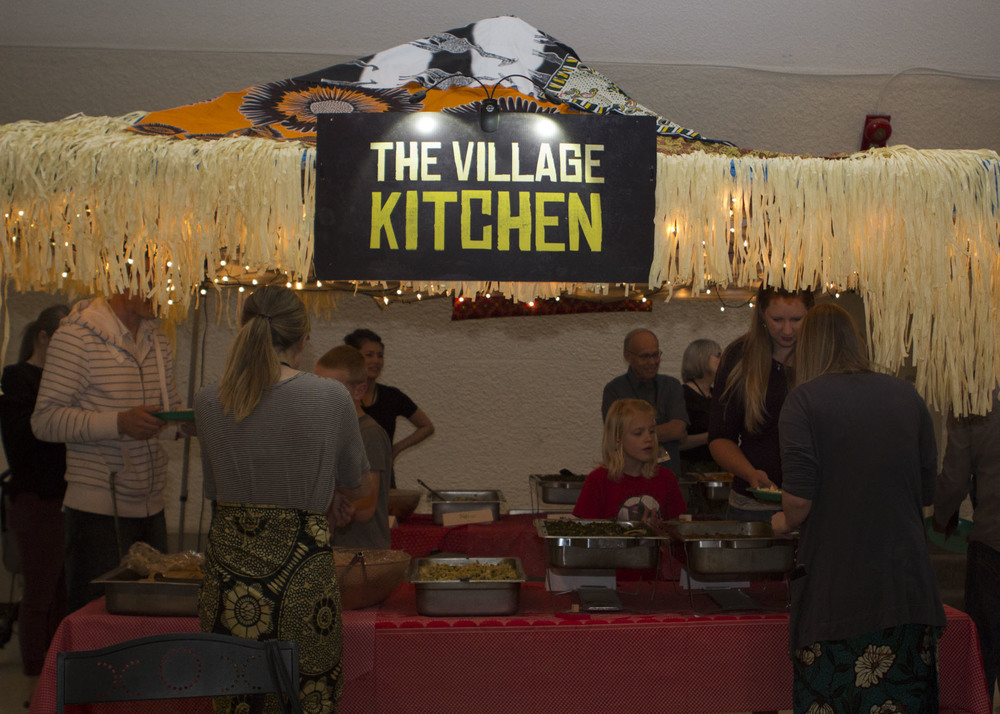  Westside volunteers serving a selection of delicious African foods. 