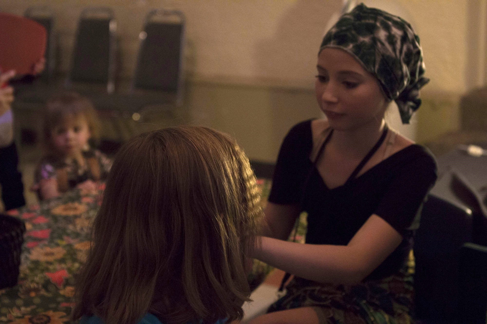  A Westside volunteer braiding hair at the salon booth 