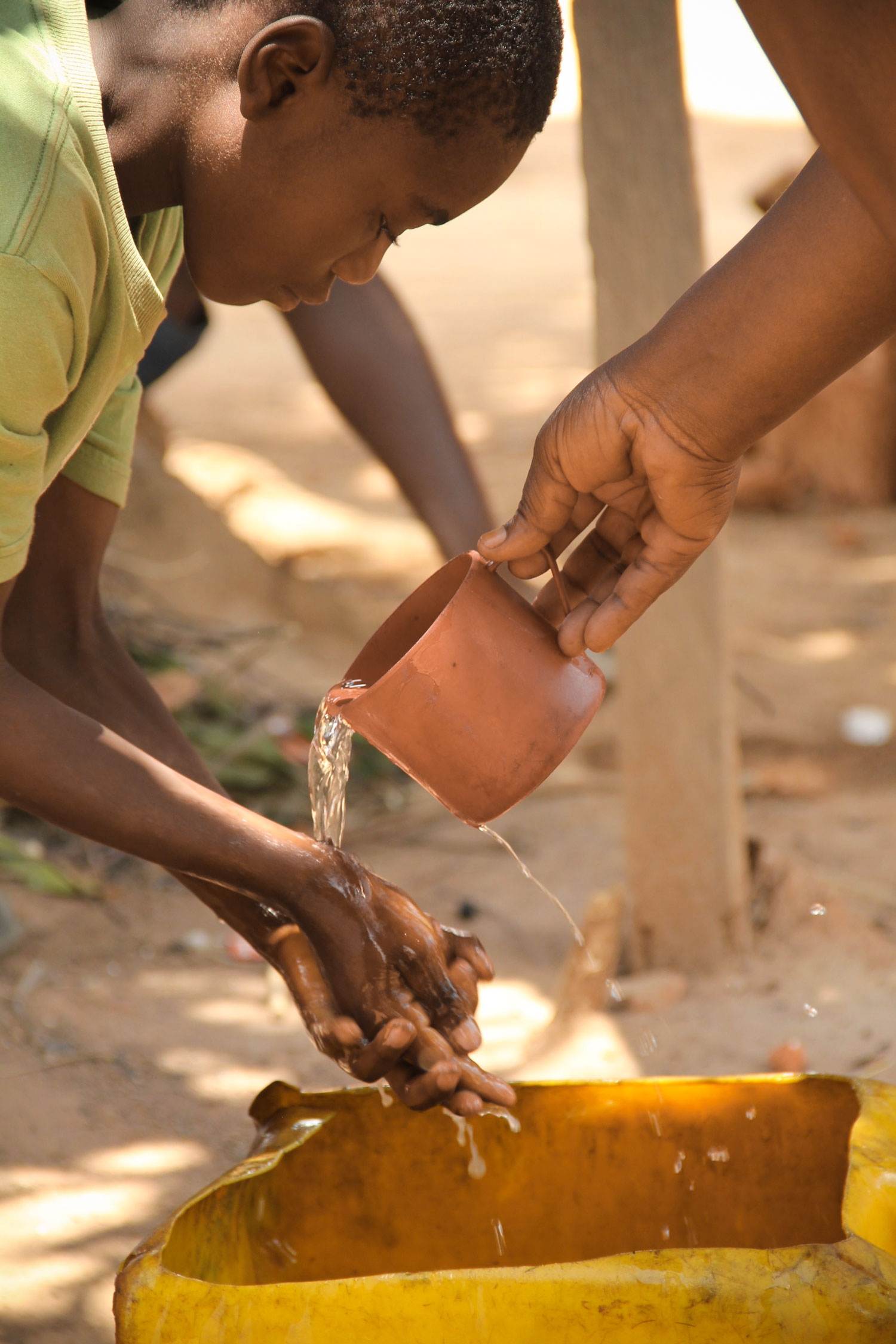 The Care Workers are committed to bringing life and God’s love to the children they serve even with the simple act of washing the children’s hands. 