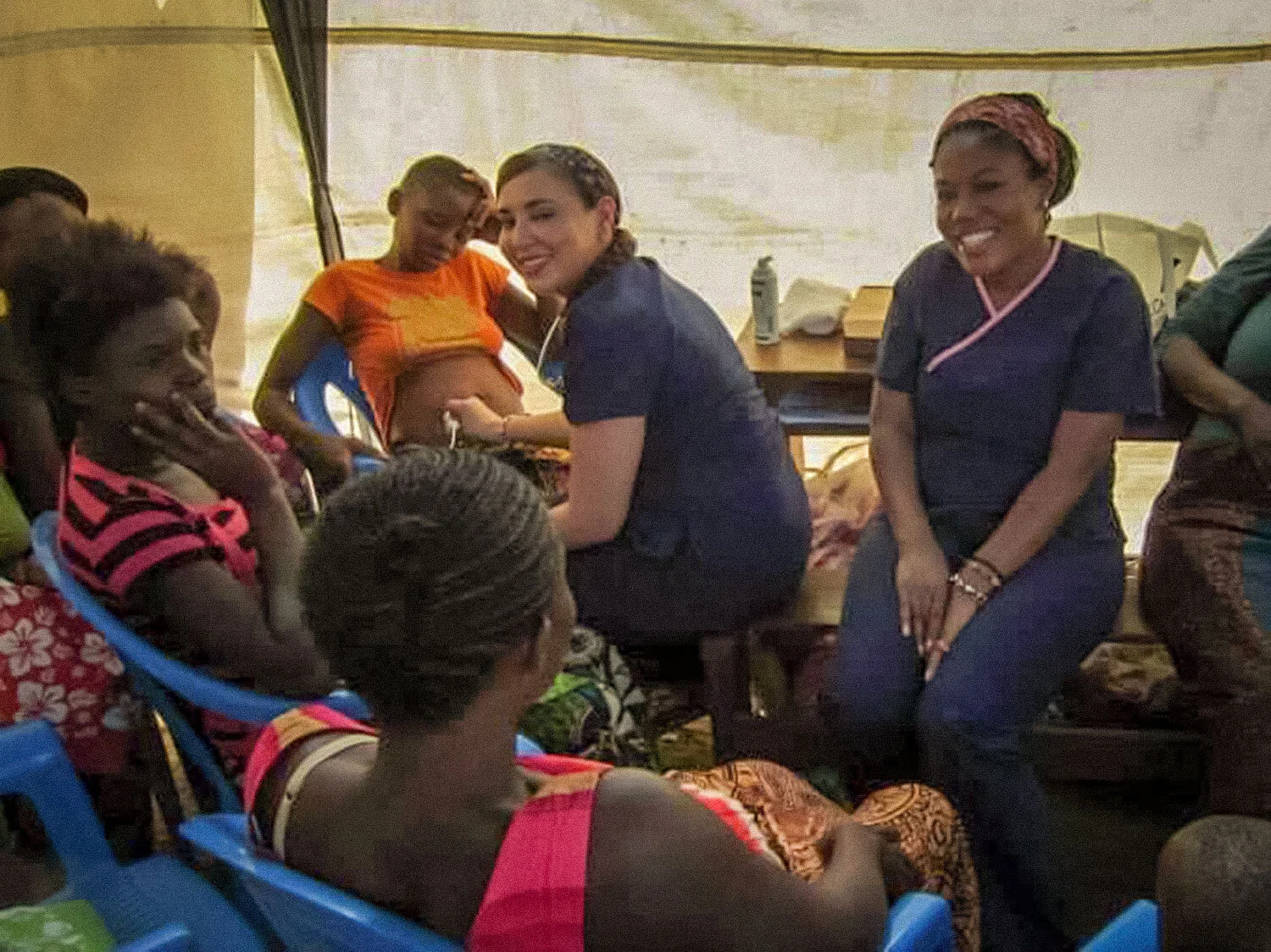  Volunteers on the Medical Missions teams taking an ultrasound of a pregnant young woman in the community during the clinic day.  